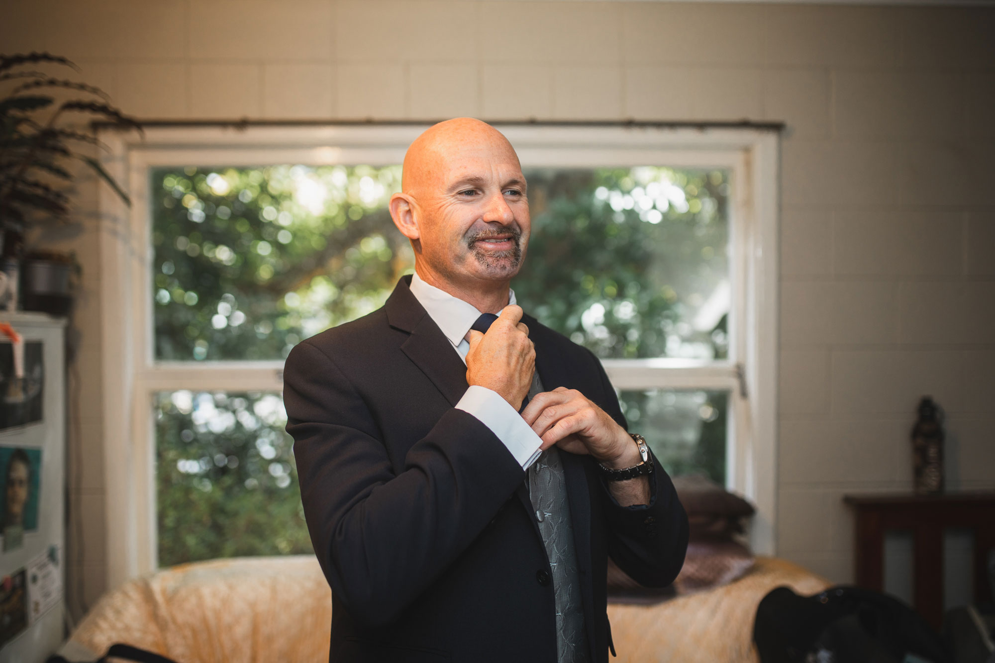 groom putting on suit