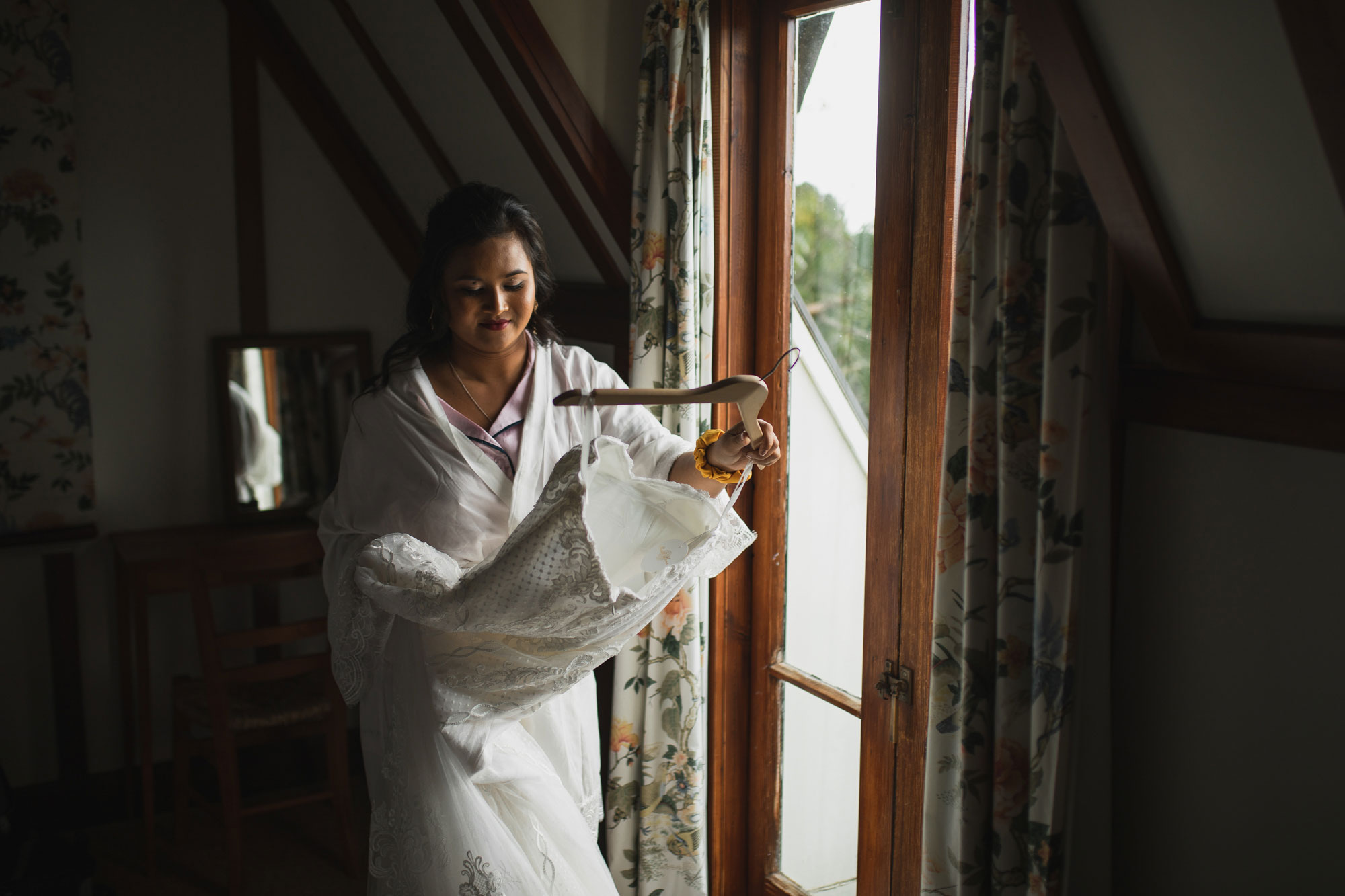 hawke's bay wedding bride looking at dress