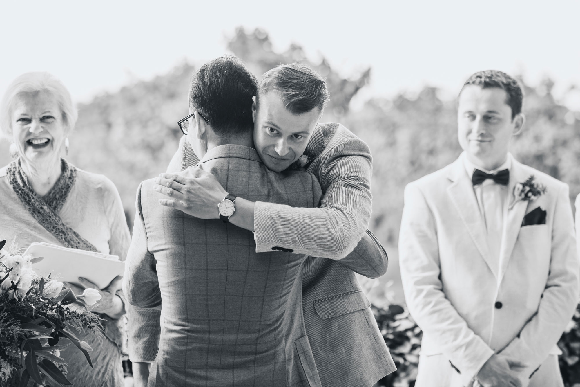 hawke's bay wedding groom hugging father of bride