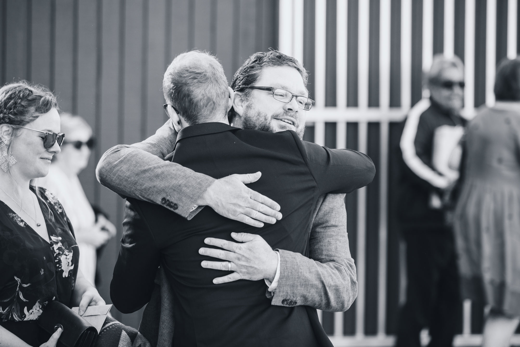 wedding guests hug