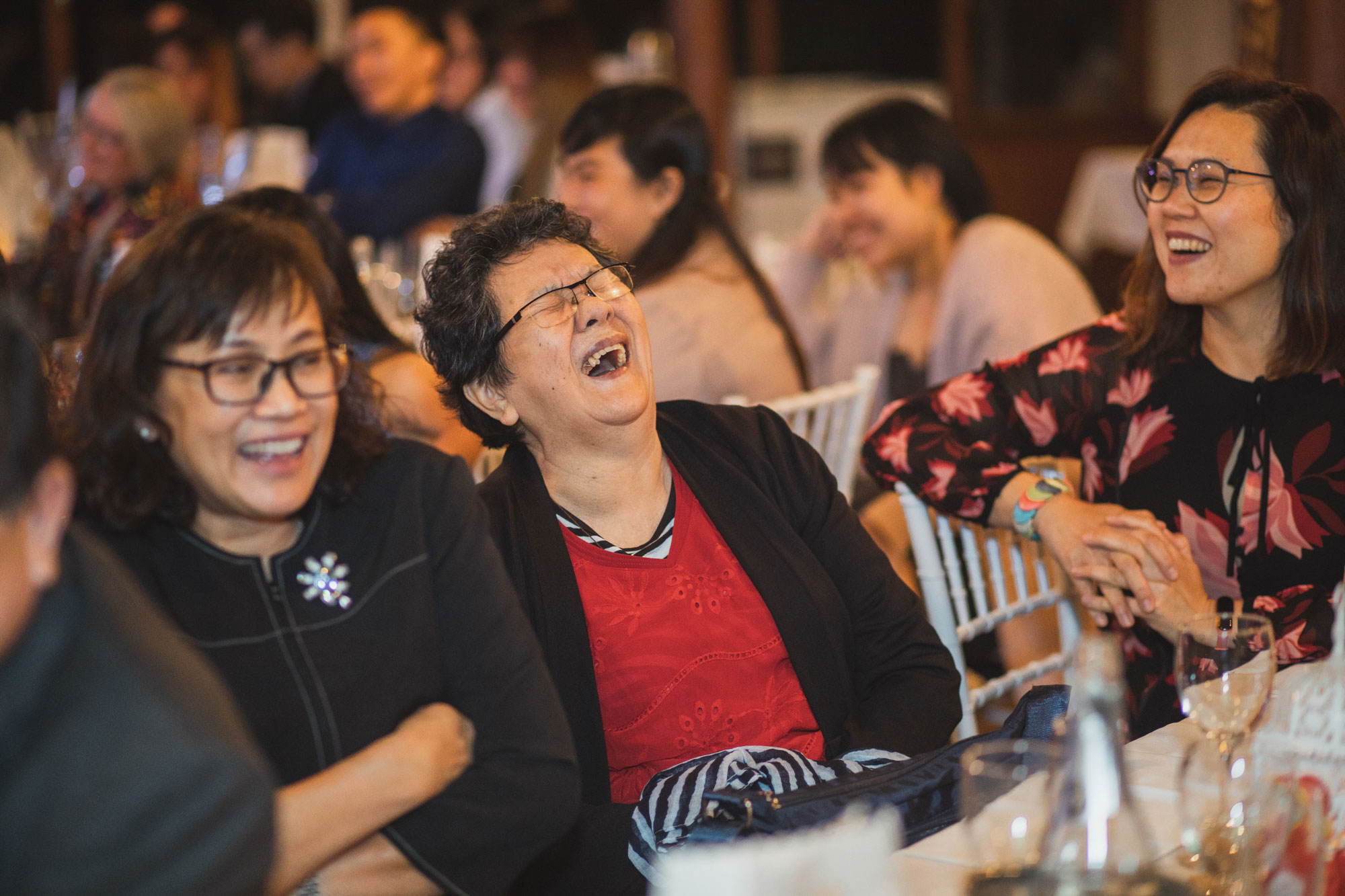 wedding guests laughing during speeches