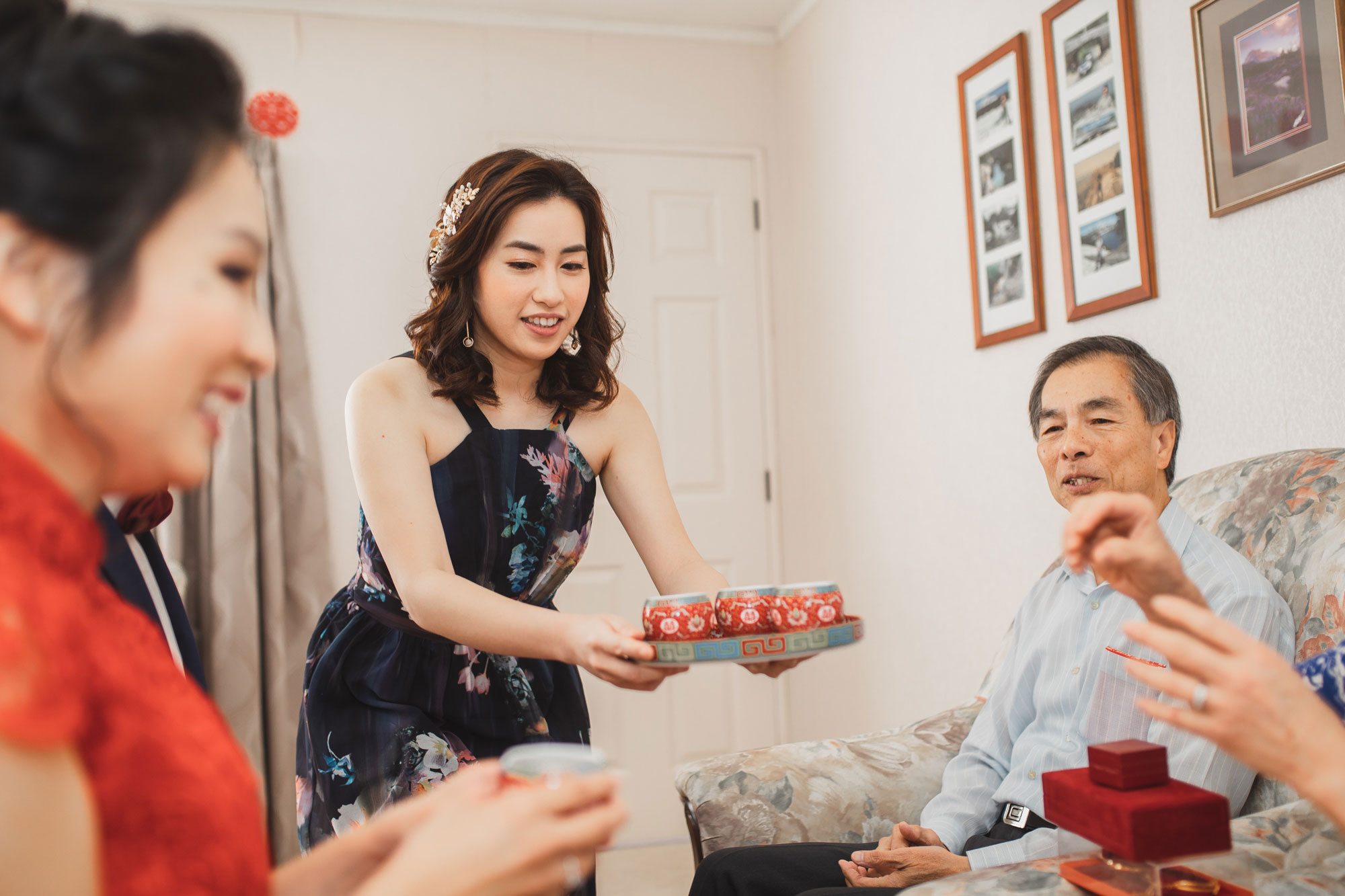 bridesmaid serving tea to elders