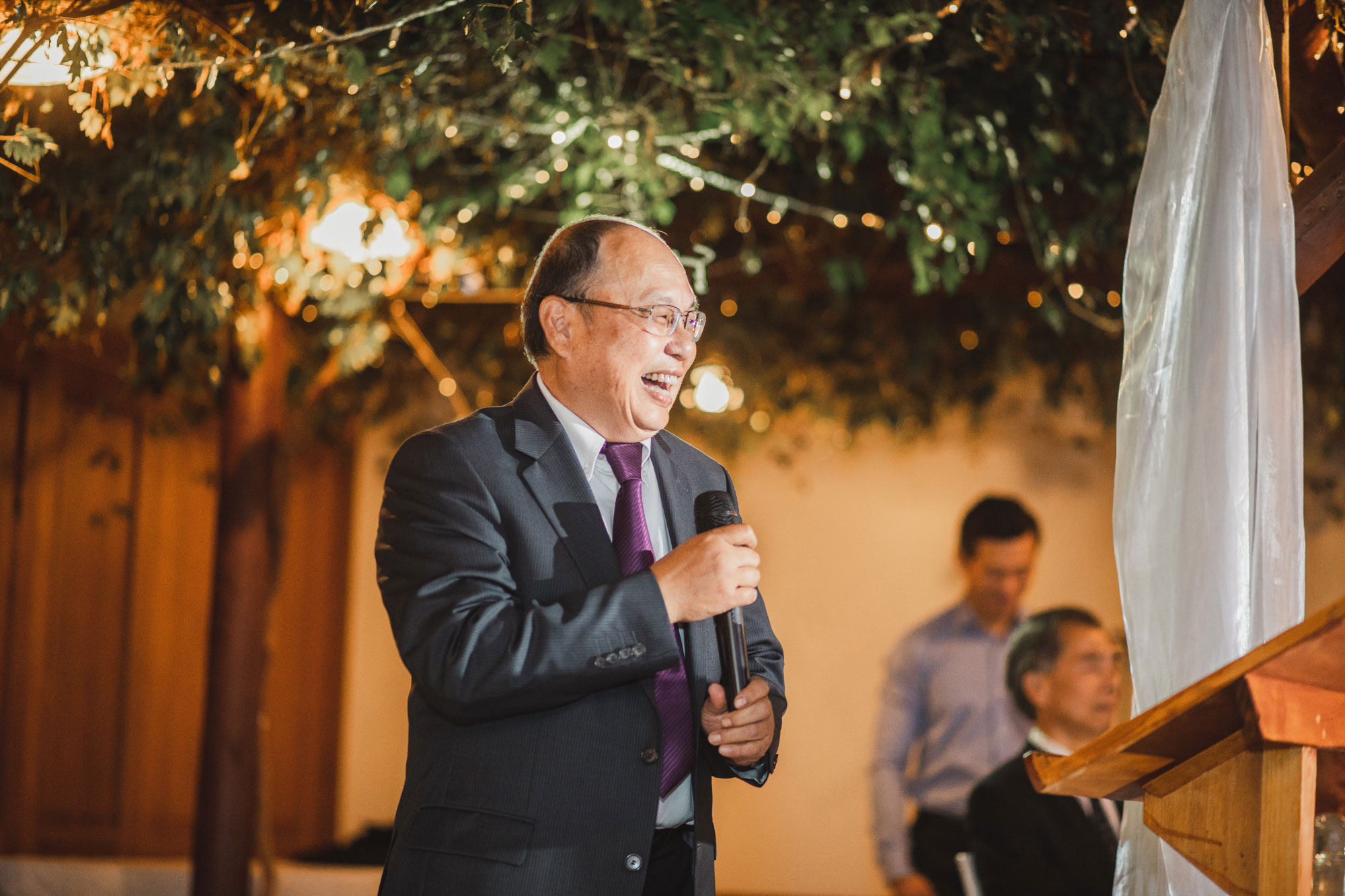 father of the groom laughing during speech