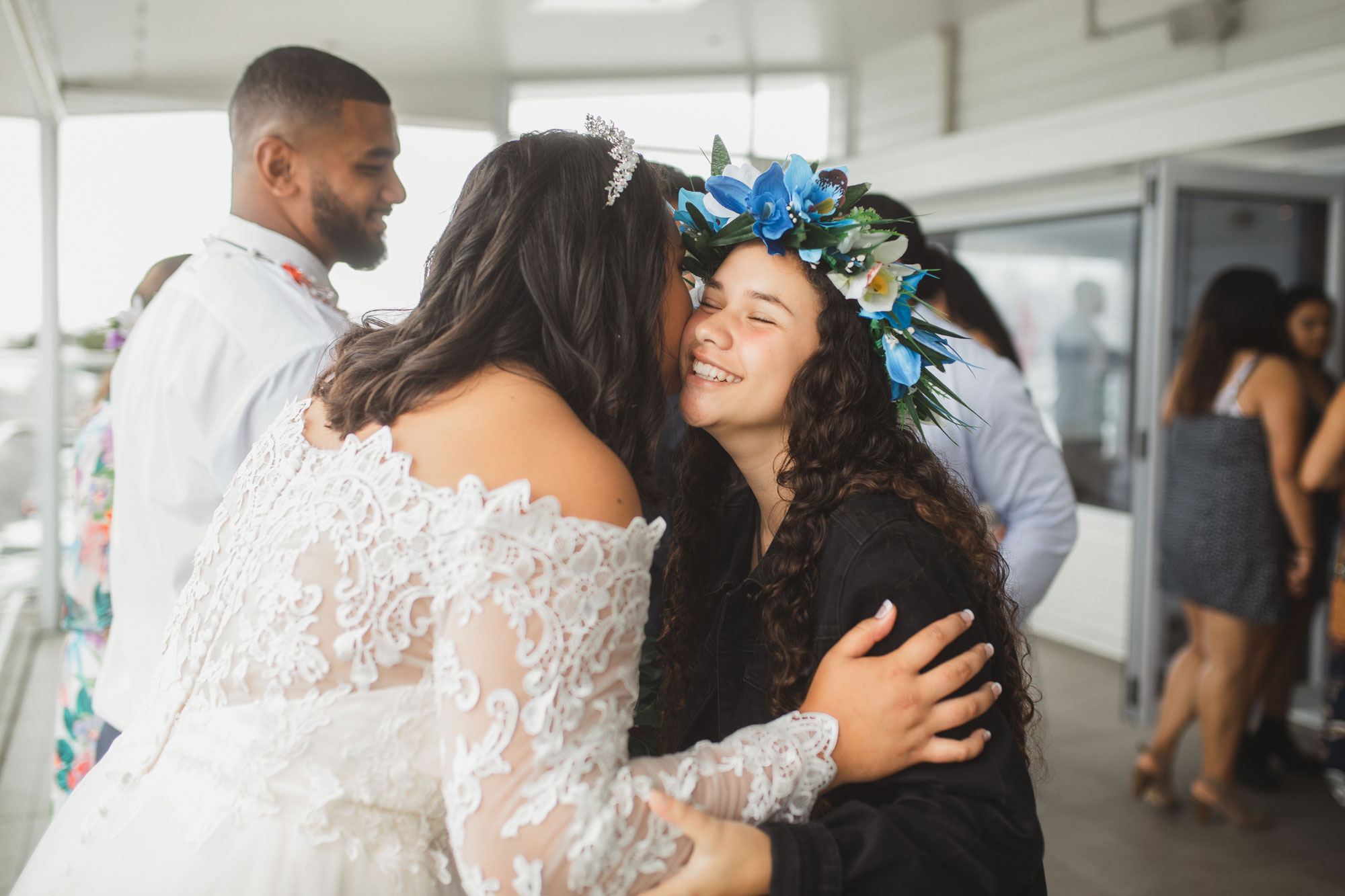 wedding guests embracing the bride