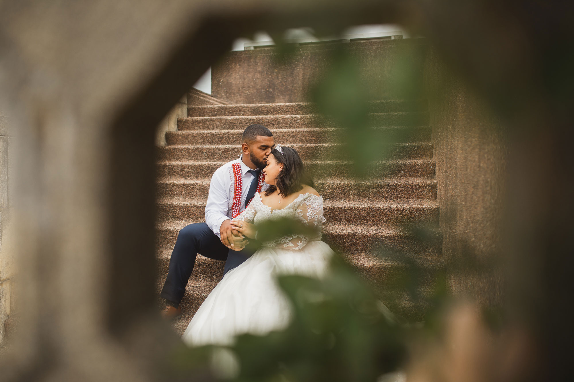 bride and groom kissing at bastion point in auckland