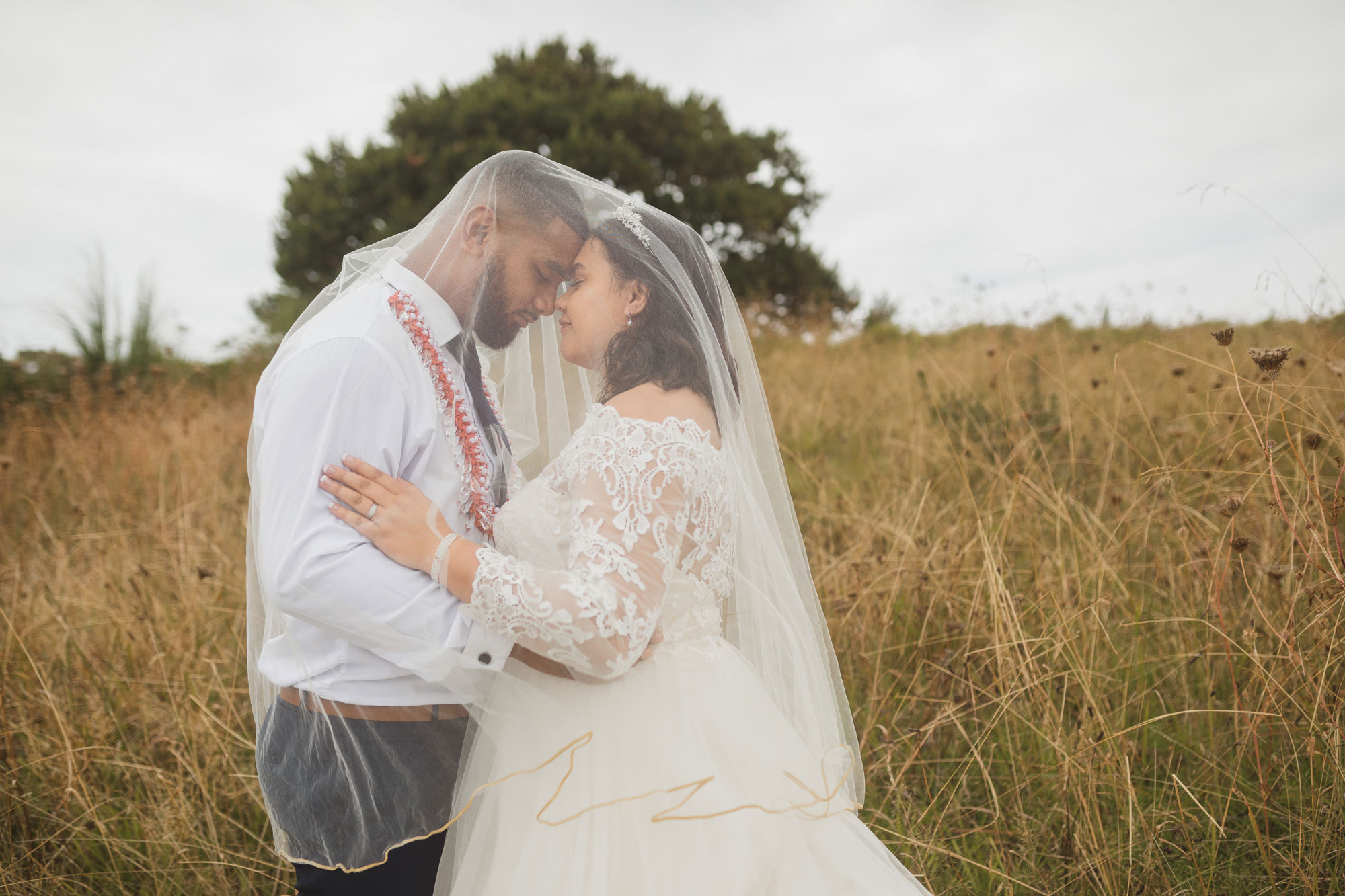 bride and groom in veil at bastion point auckland