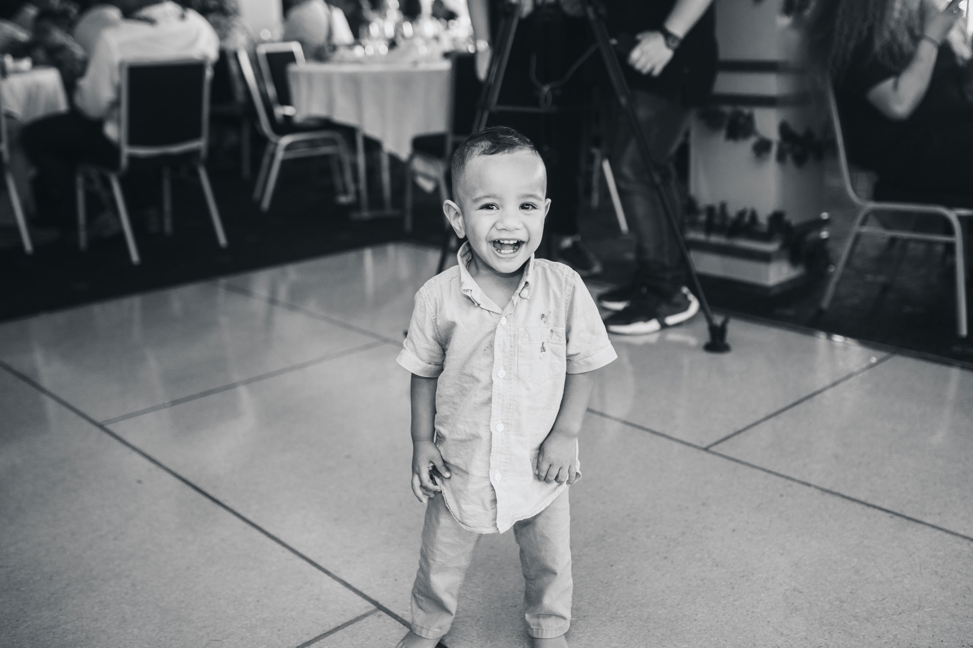 little boy smiling at wedding reception