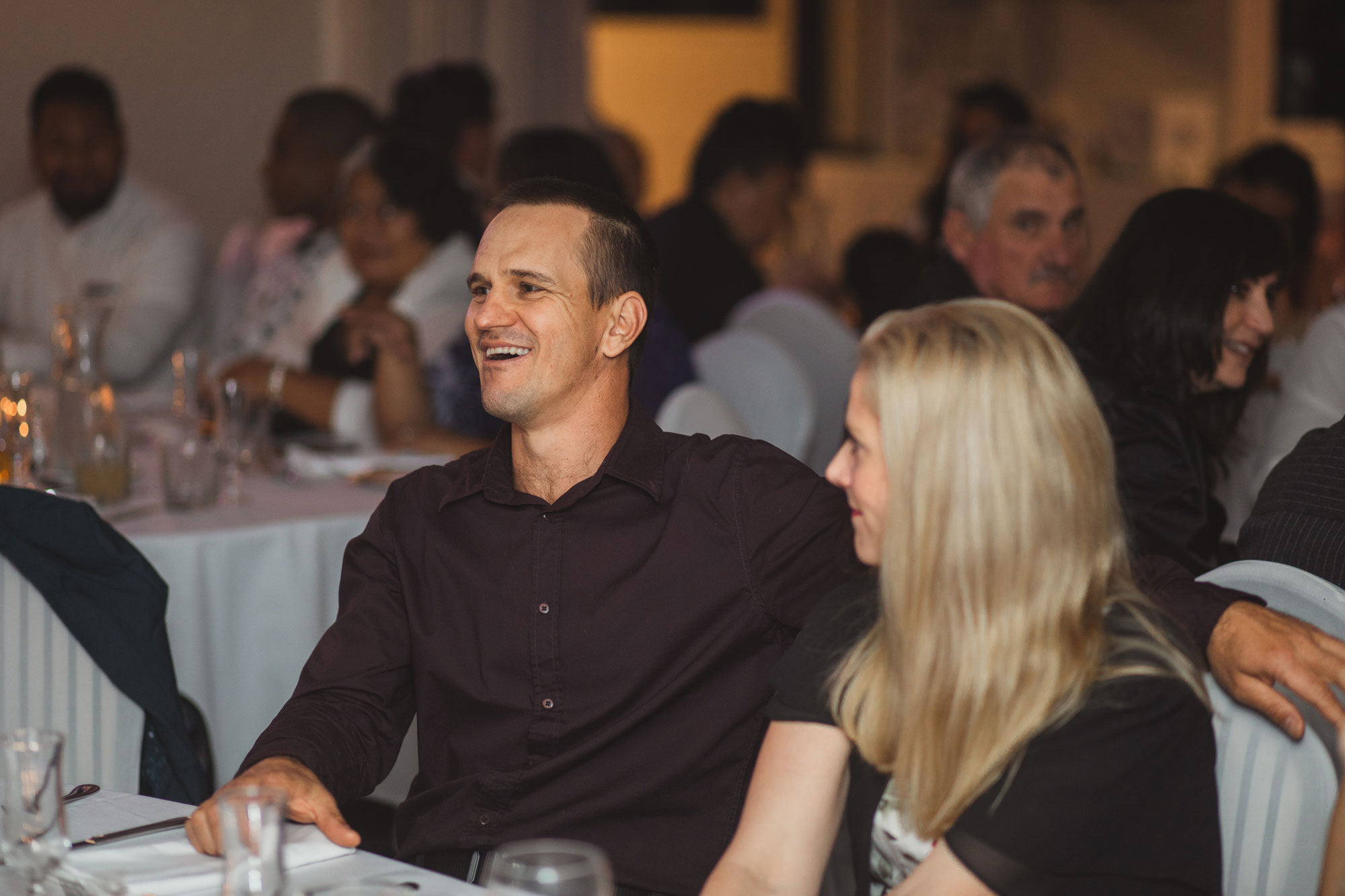 guests laughing at wedding reception