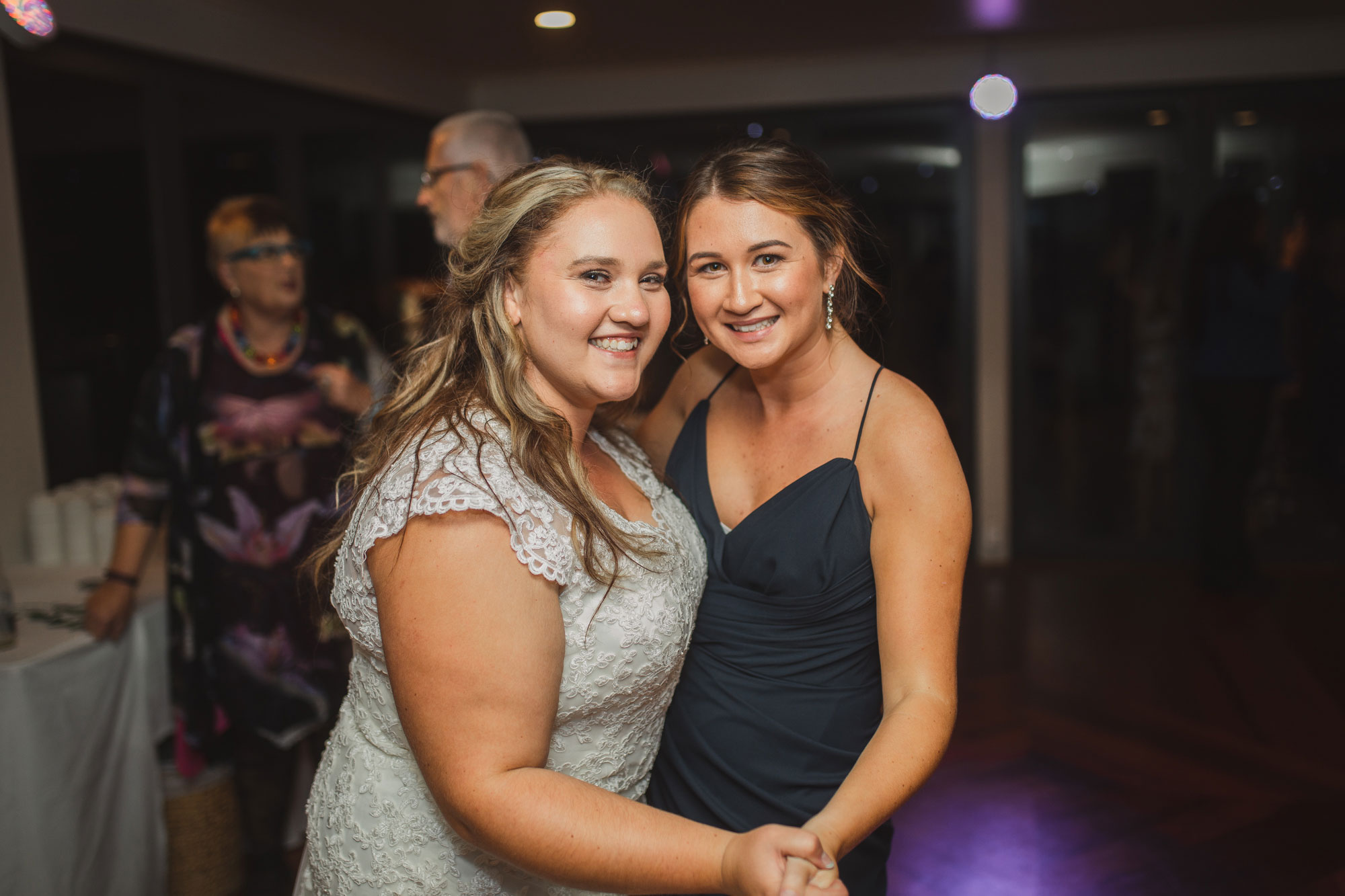 bride and bridesmaid having fun on the dance floor