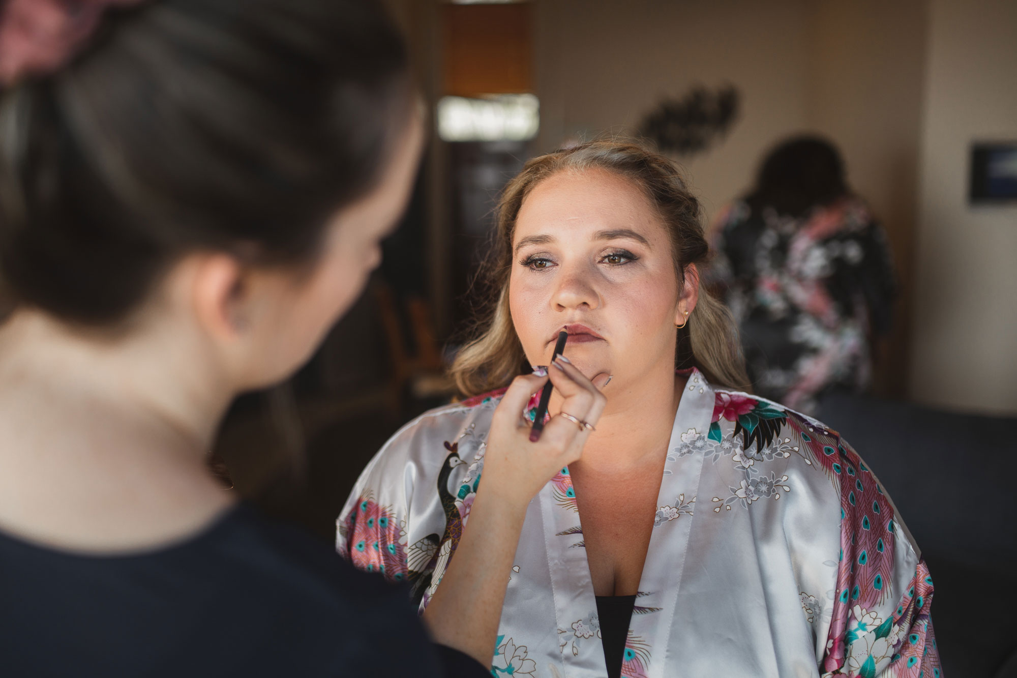 bride putting on lipstick