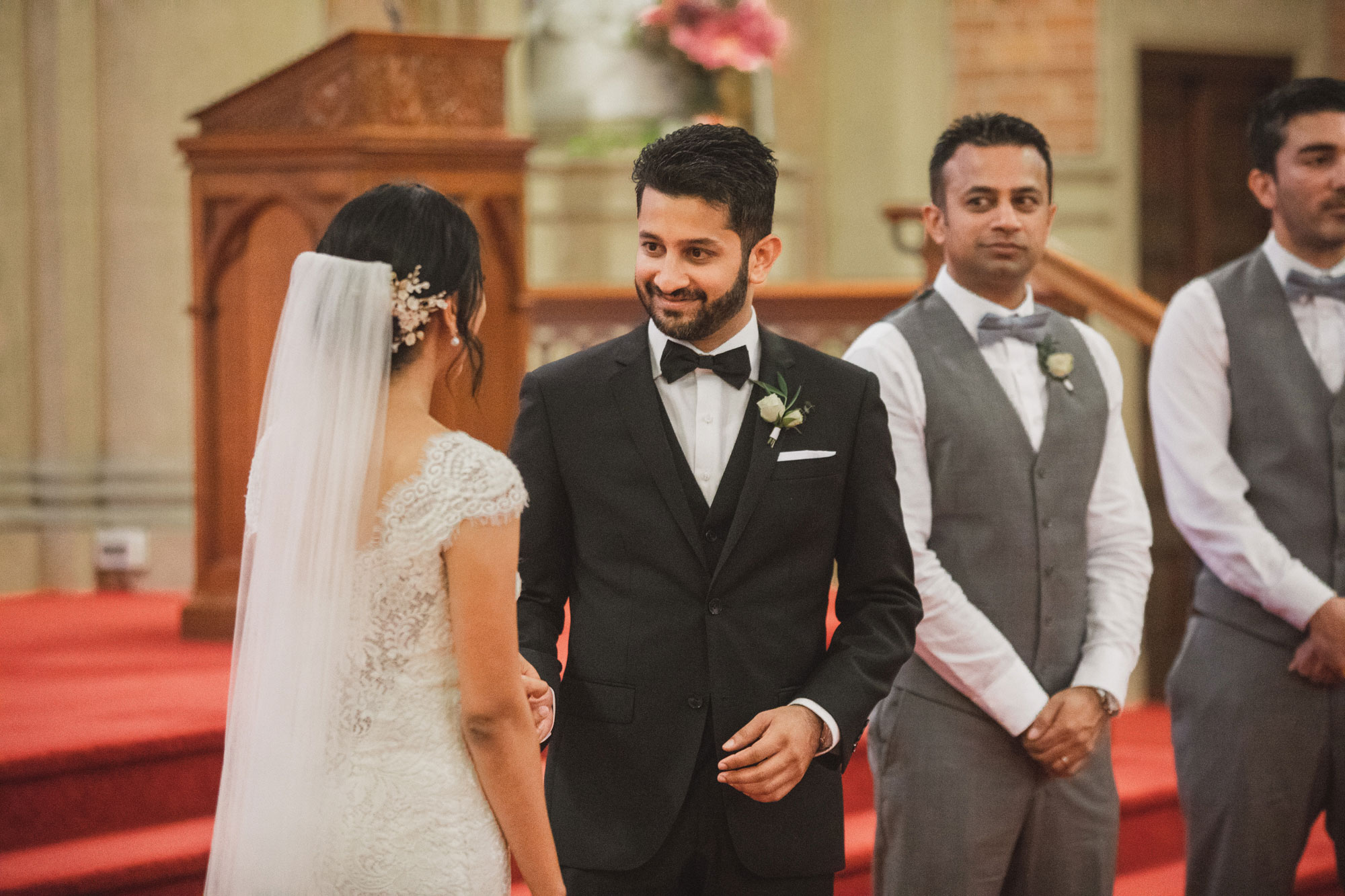 groom smiling at bride