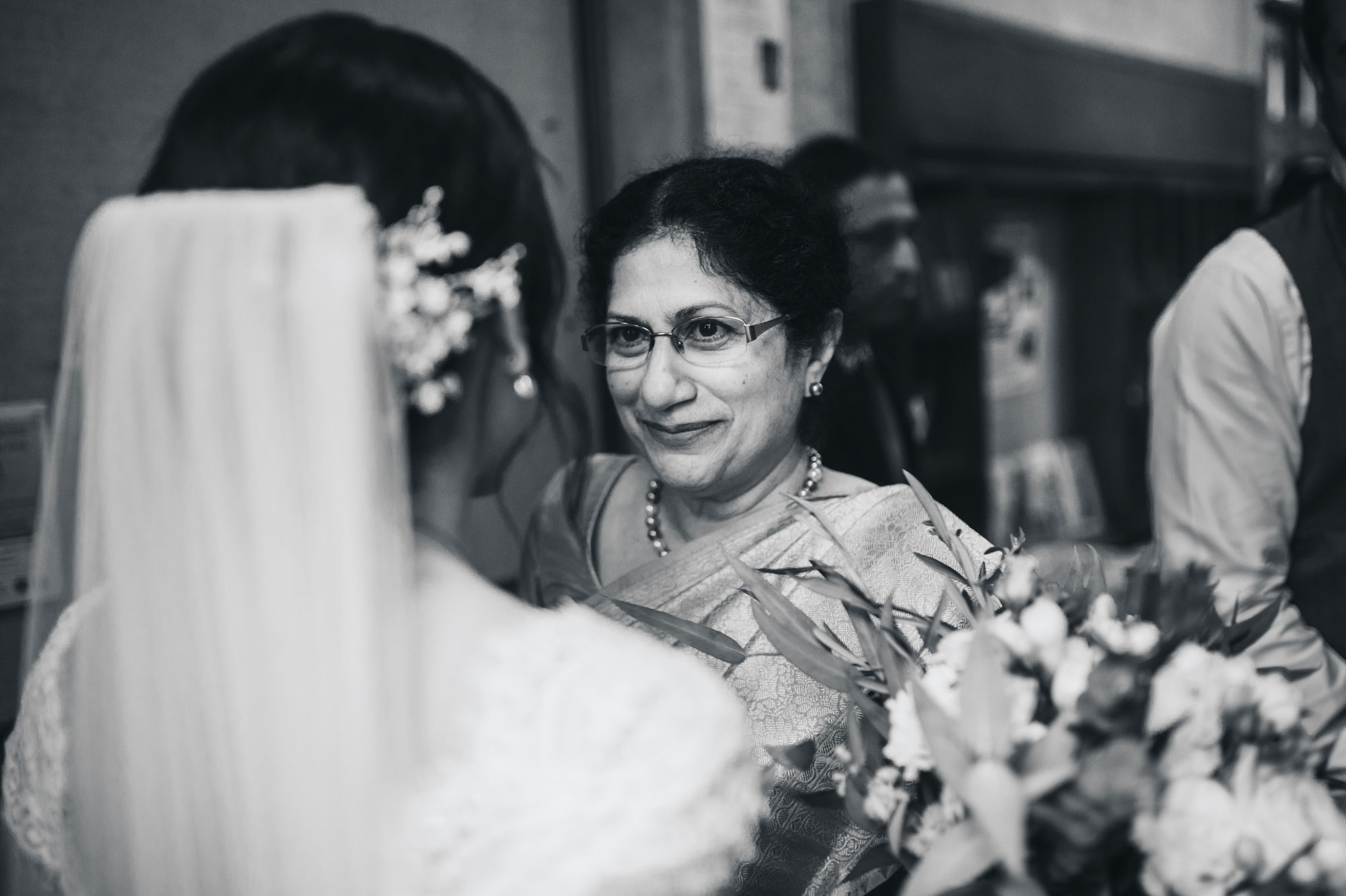 wedding guests hugging bride