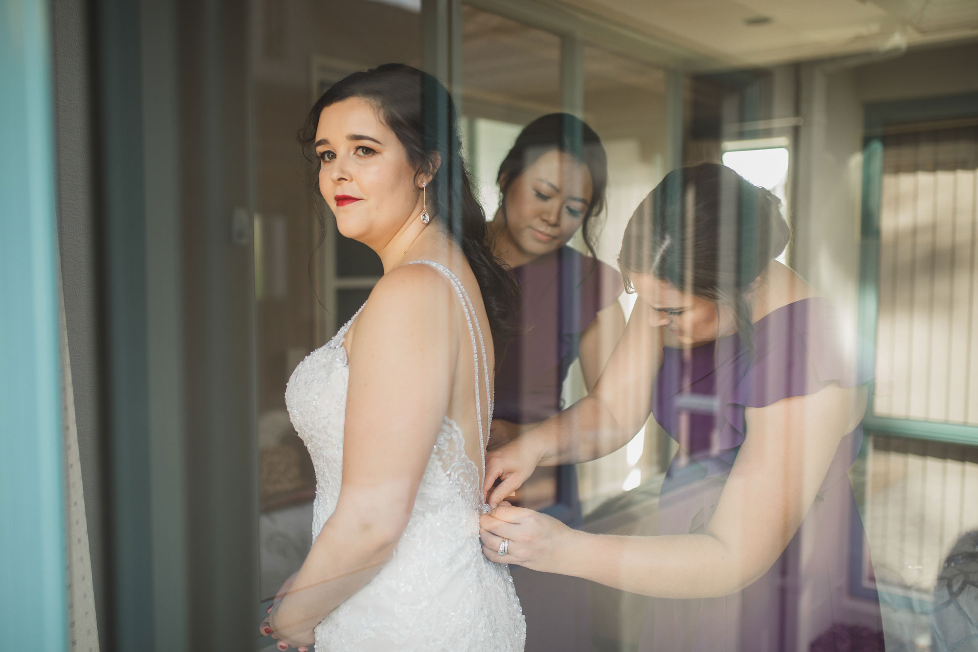 bride putting on her dress