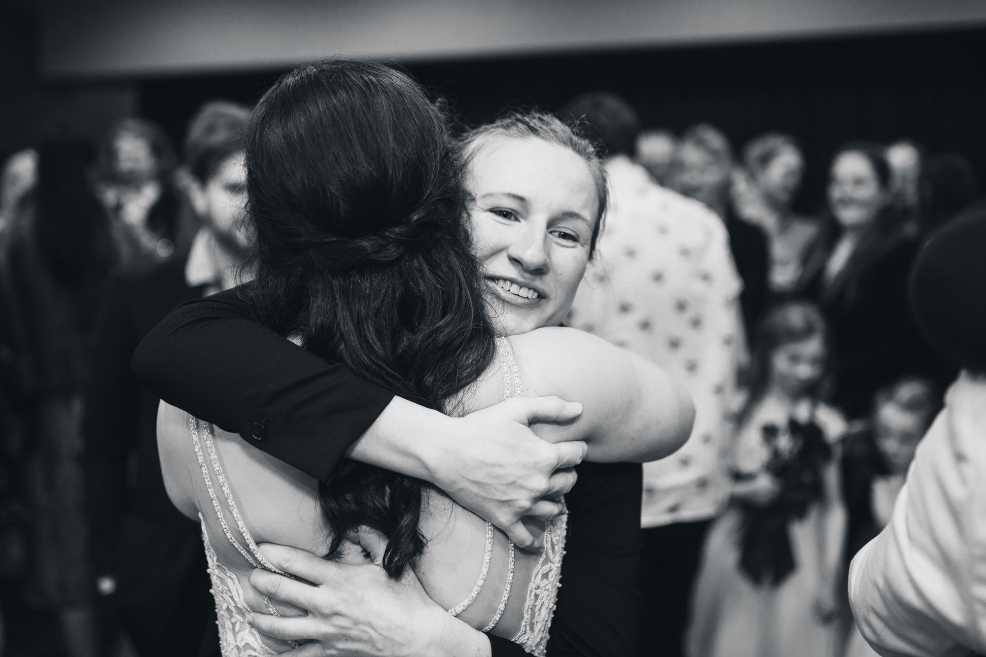 wedding guest hugging the bride