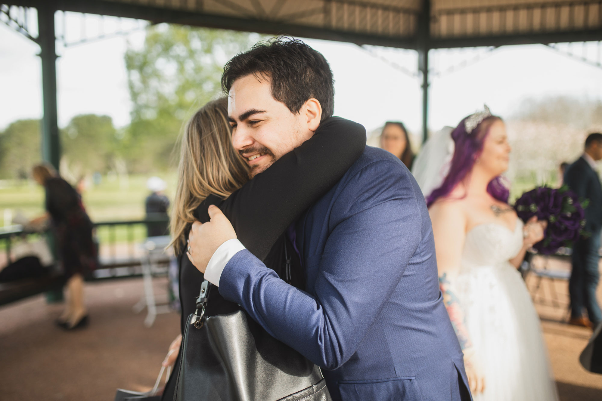 groom hugging a wedding guest