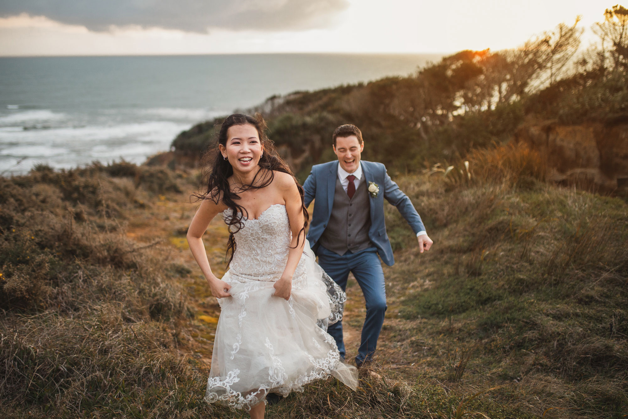 bride and groom having fun at castaways sunset shoot