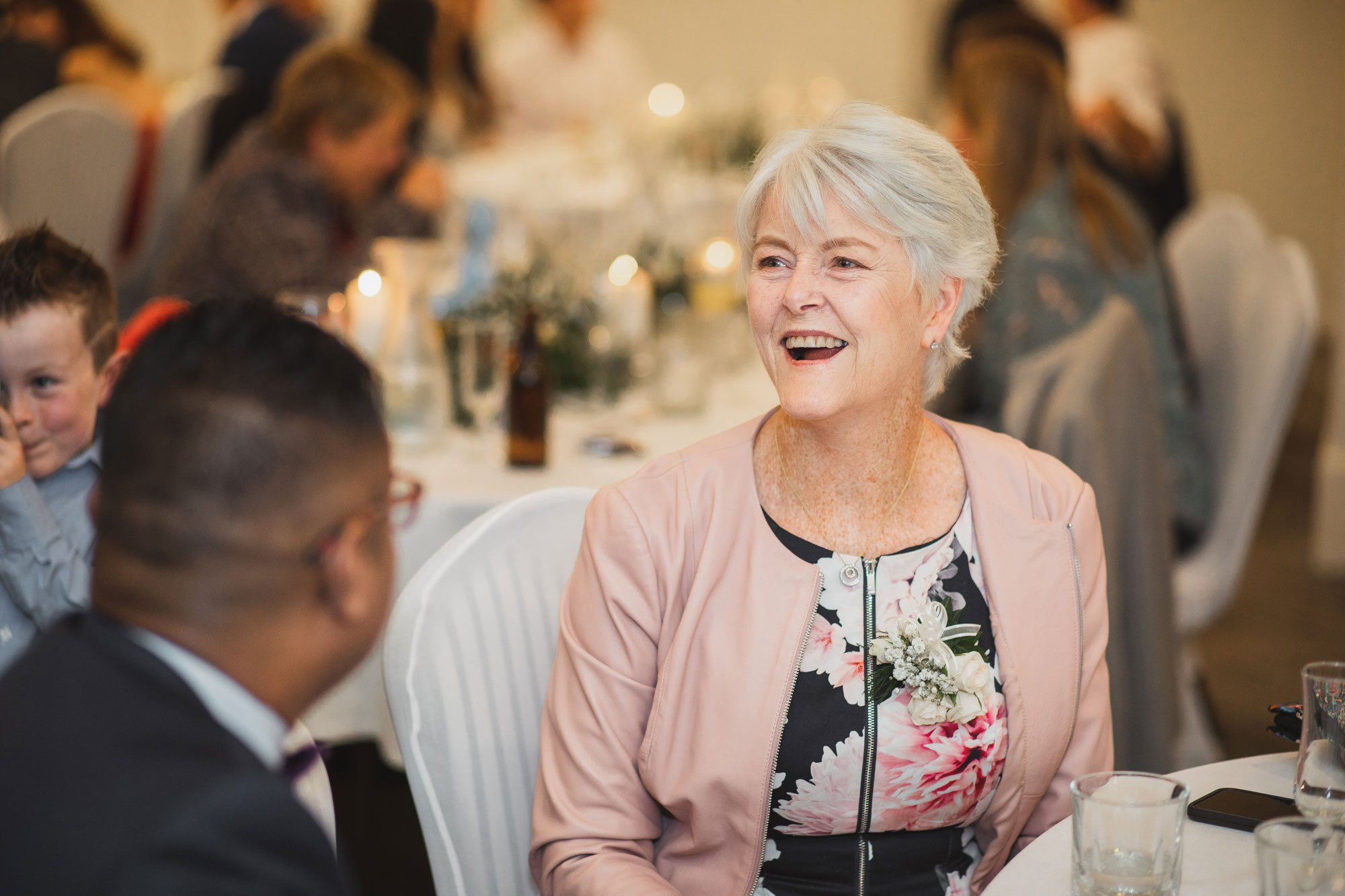 wedding guest laughing at the reception