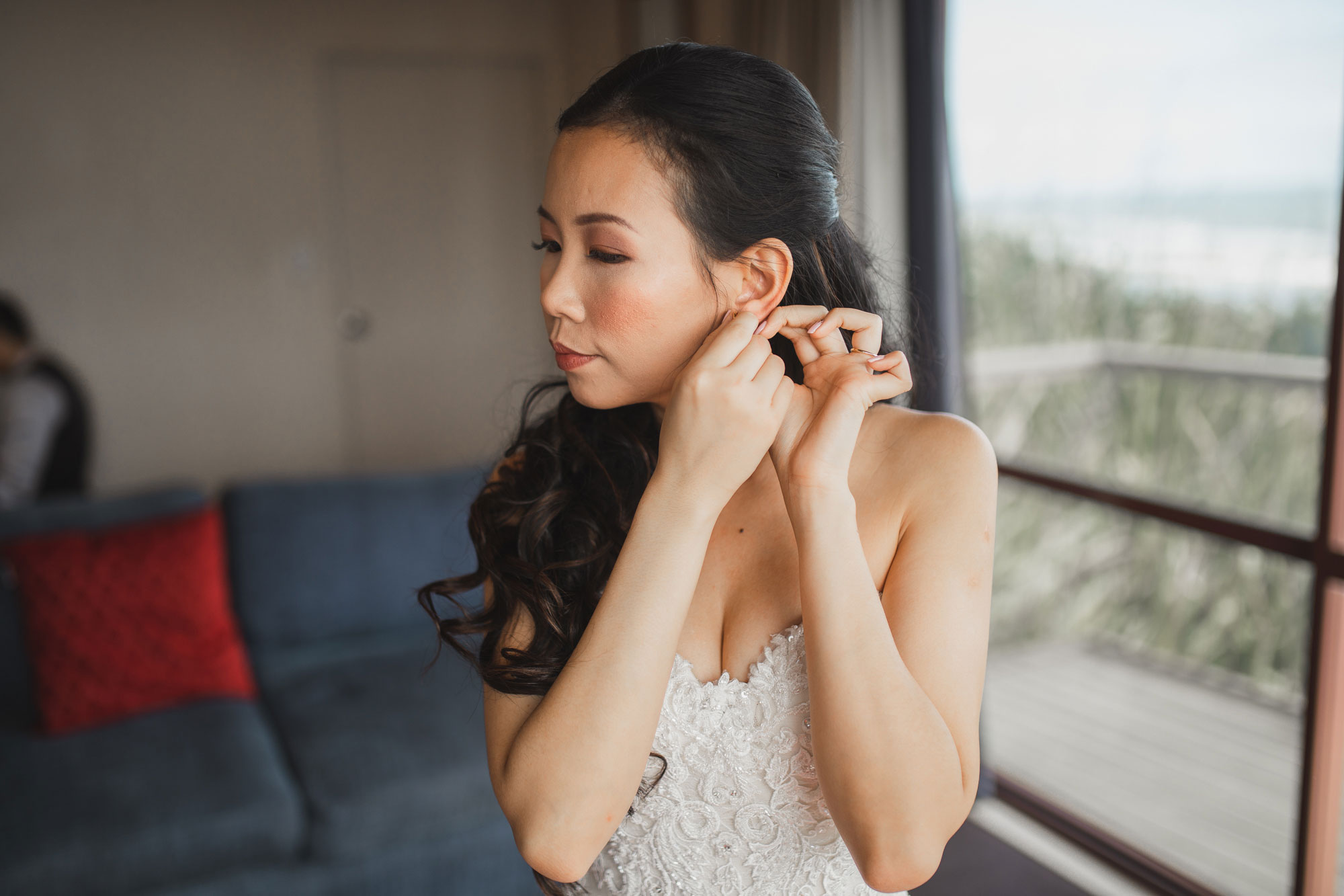 bride putting on earrings