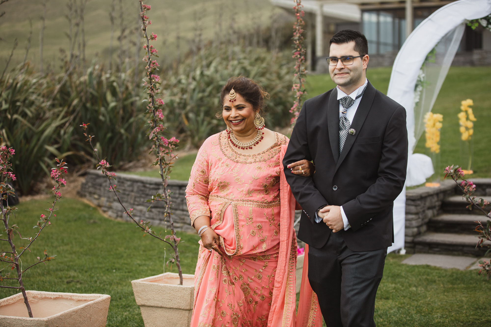 groom and mother walking down the aisle