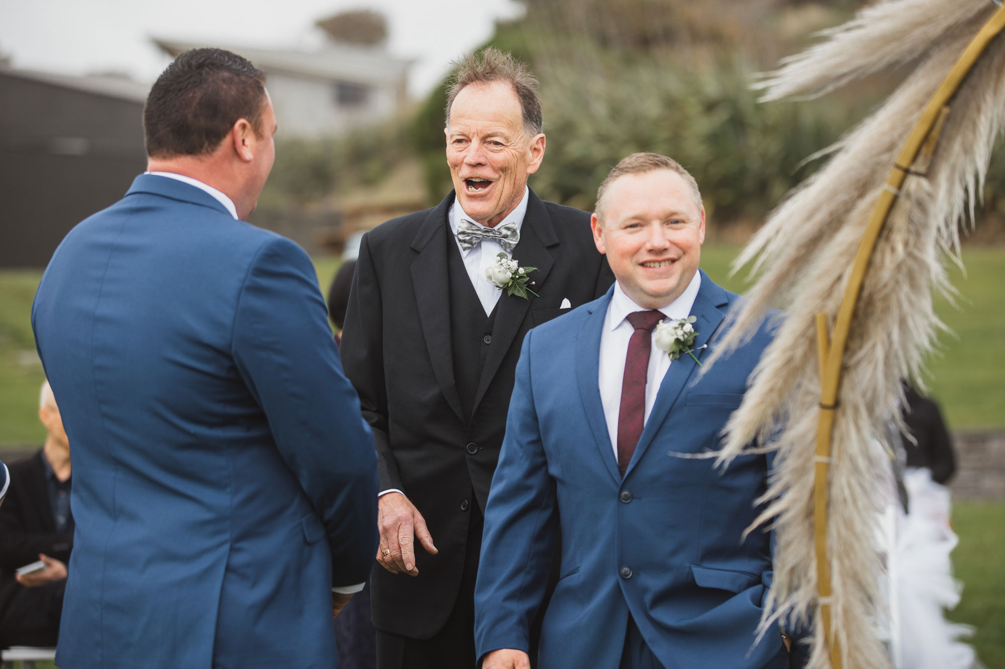 father of the groom laughing