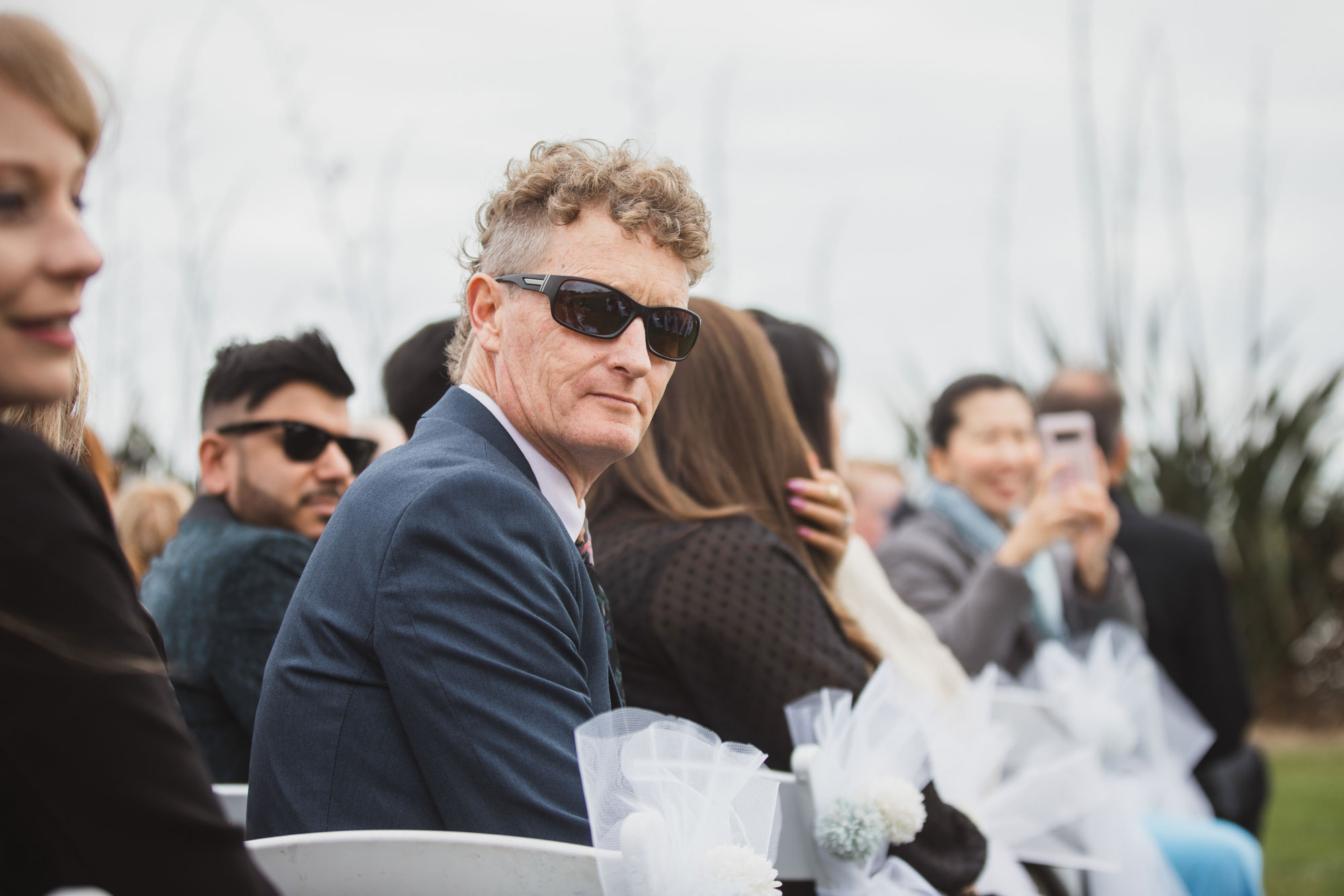 wedding guests looking at the flowergirl