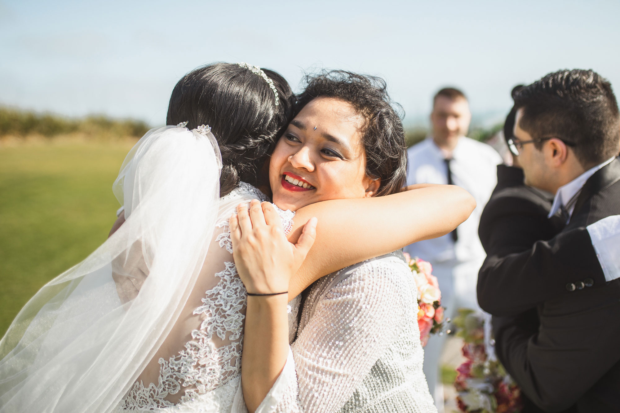 guest hugging the bride