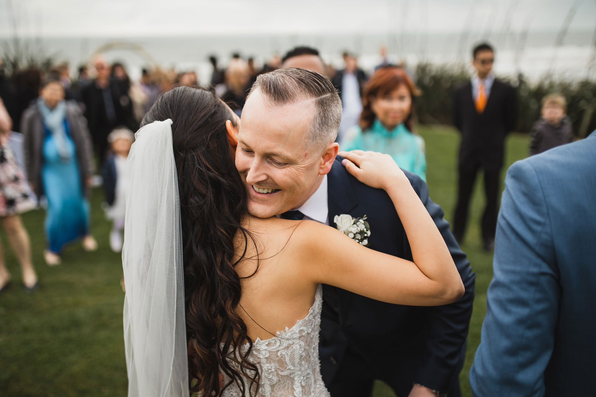 brother of the groom hugging bride