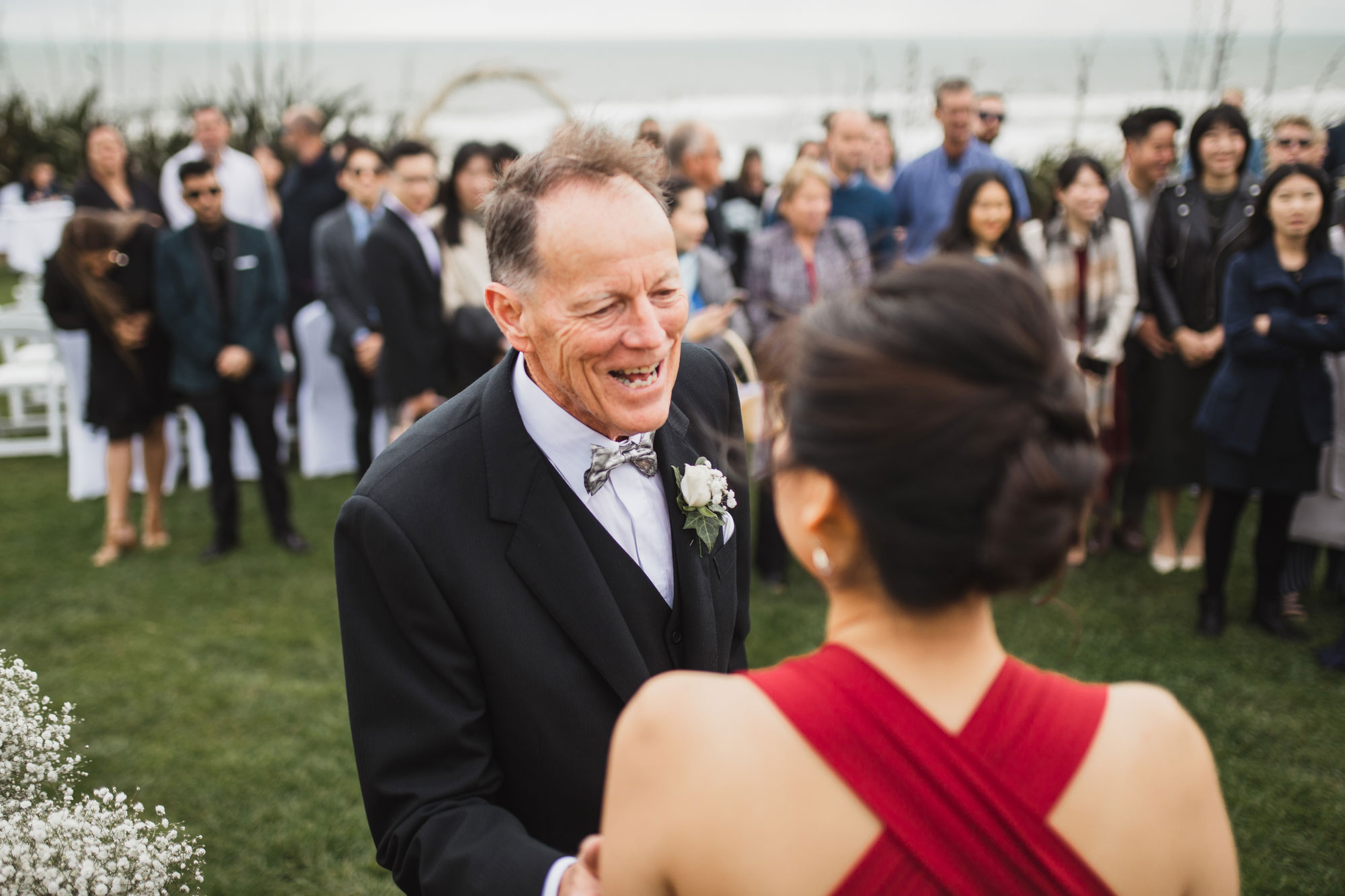 father of the bride talking to bridesmaid