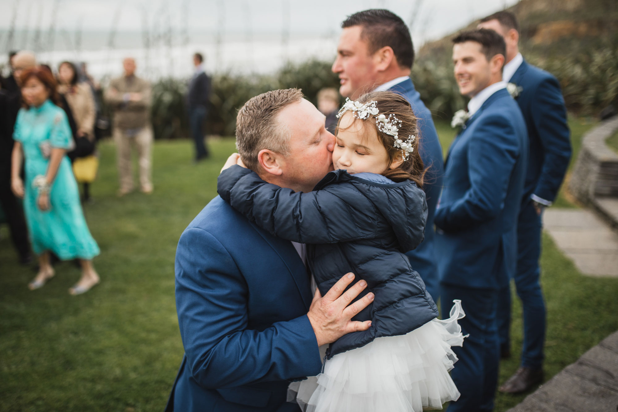 groomsman kissing daughter