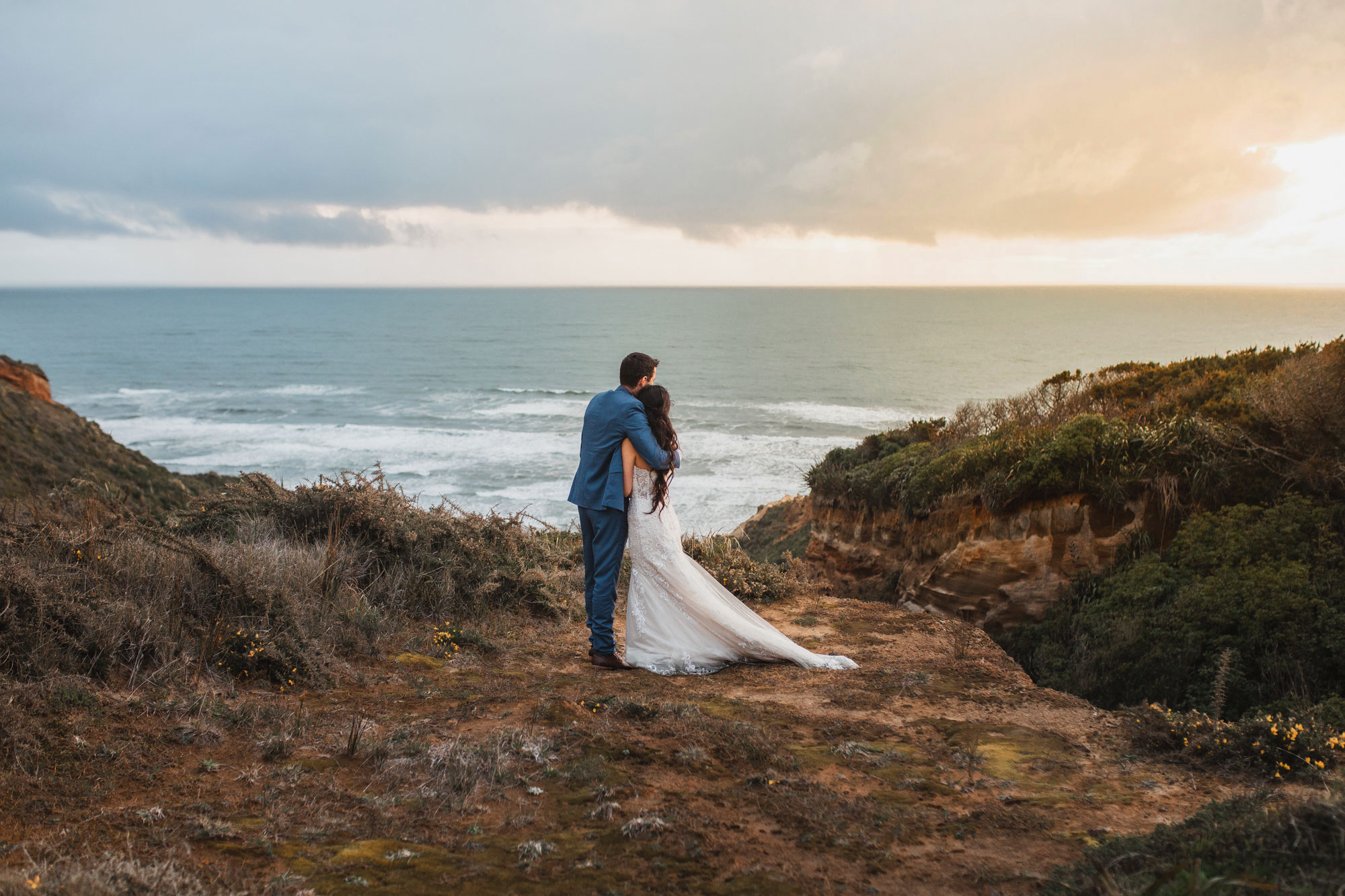 bride and groom overlooking the ocean