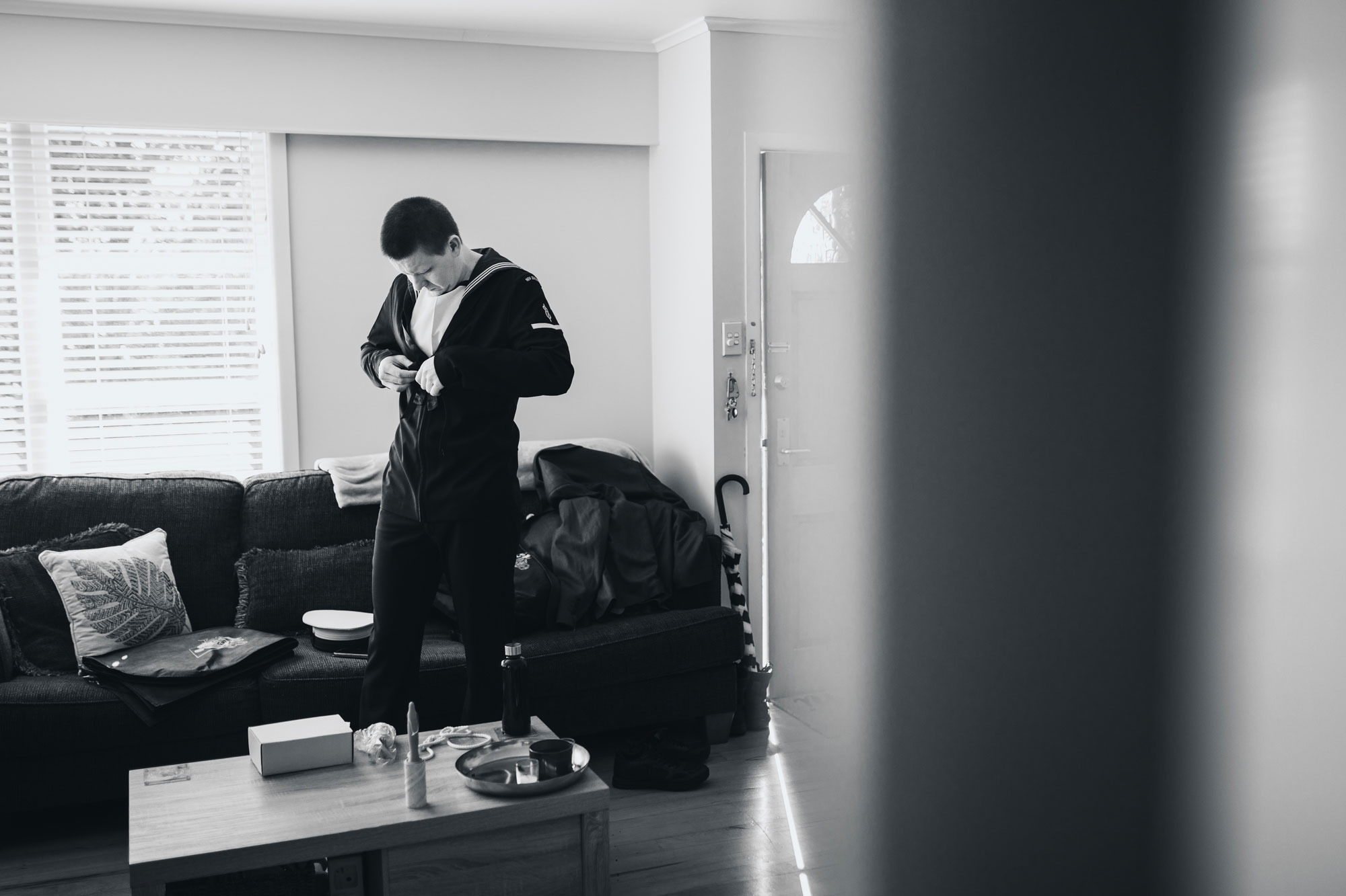 groom getting ready black and white