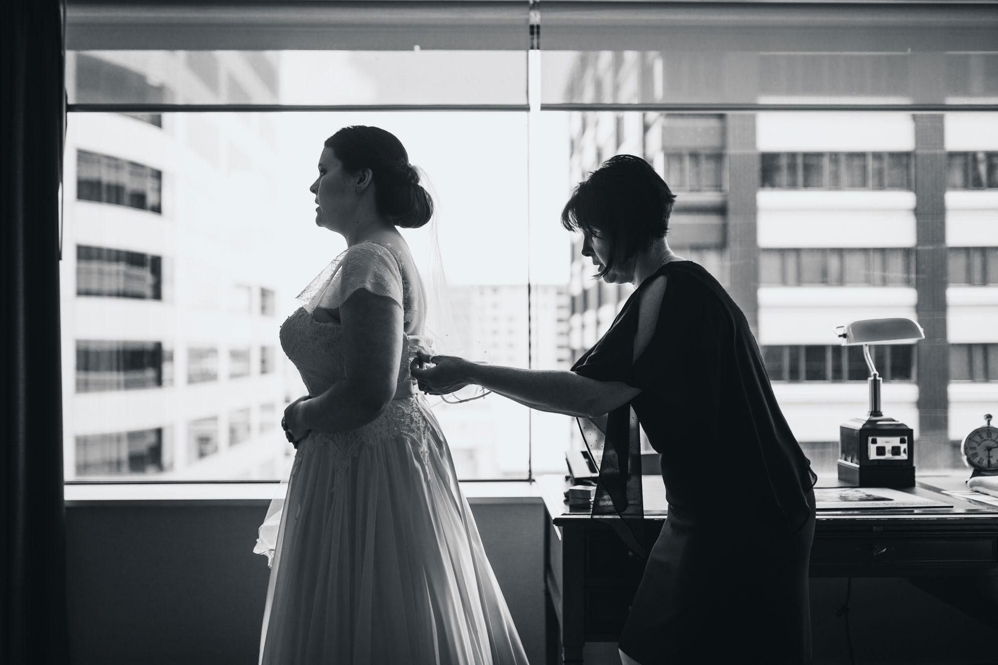 bride mother tying her dress up