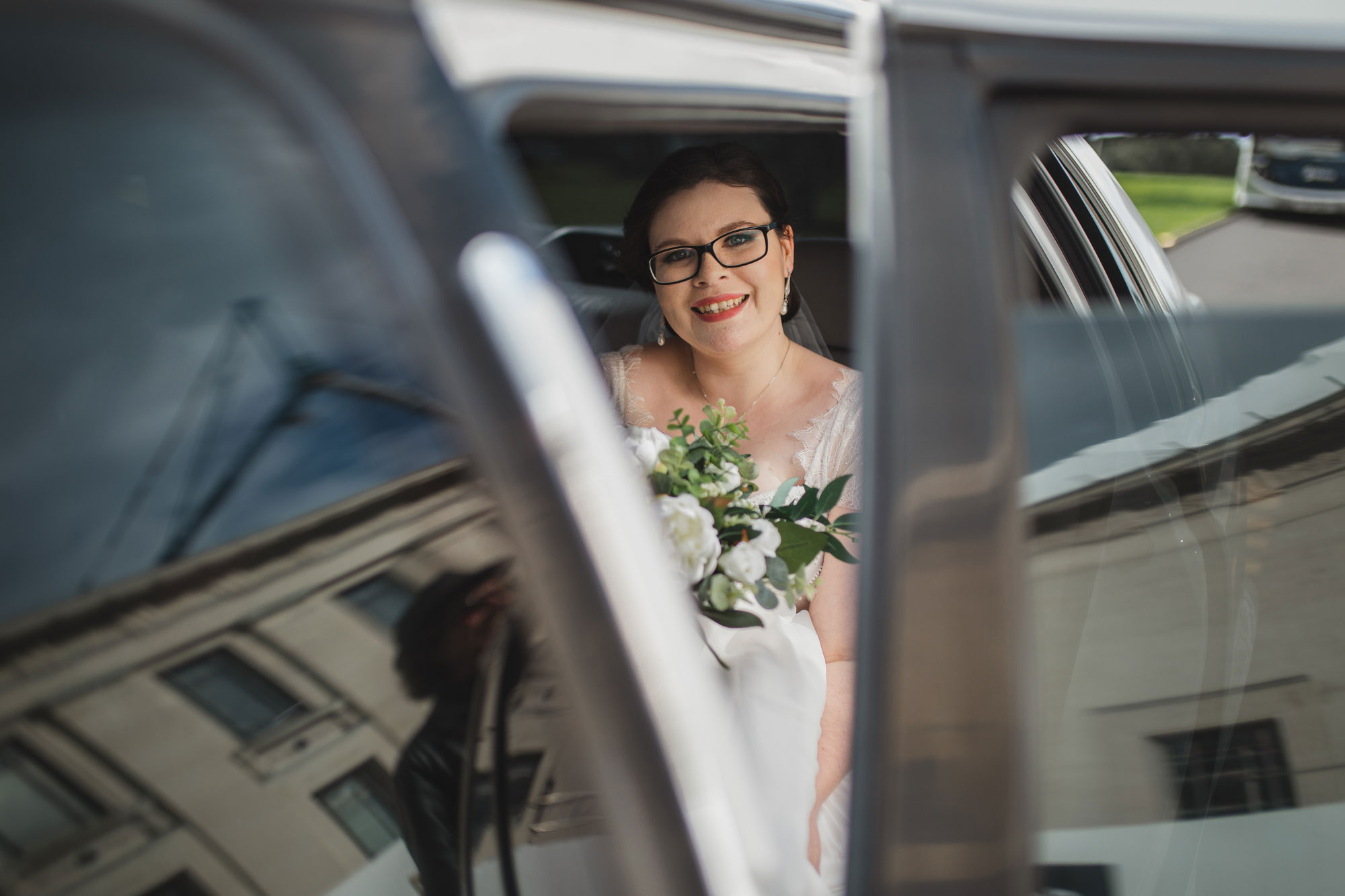 bride entering wedding car