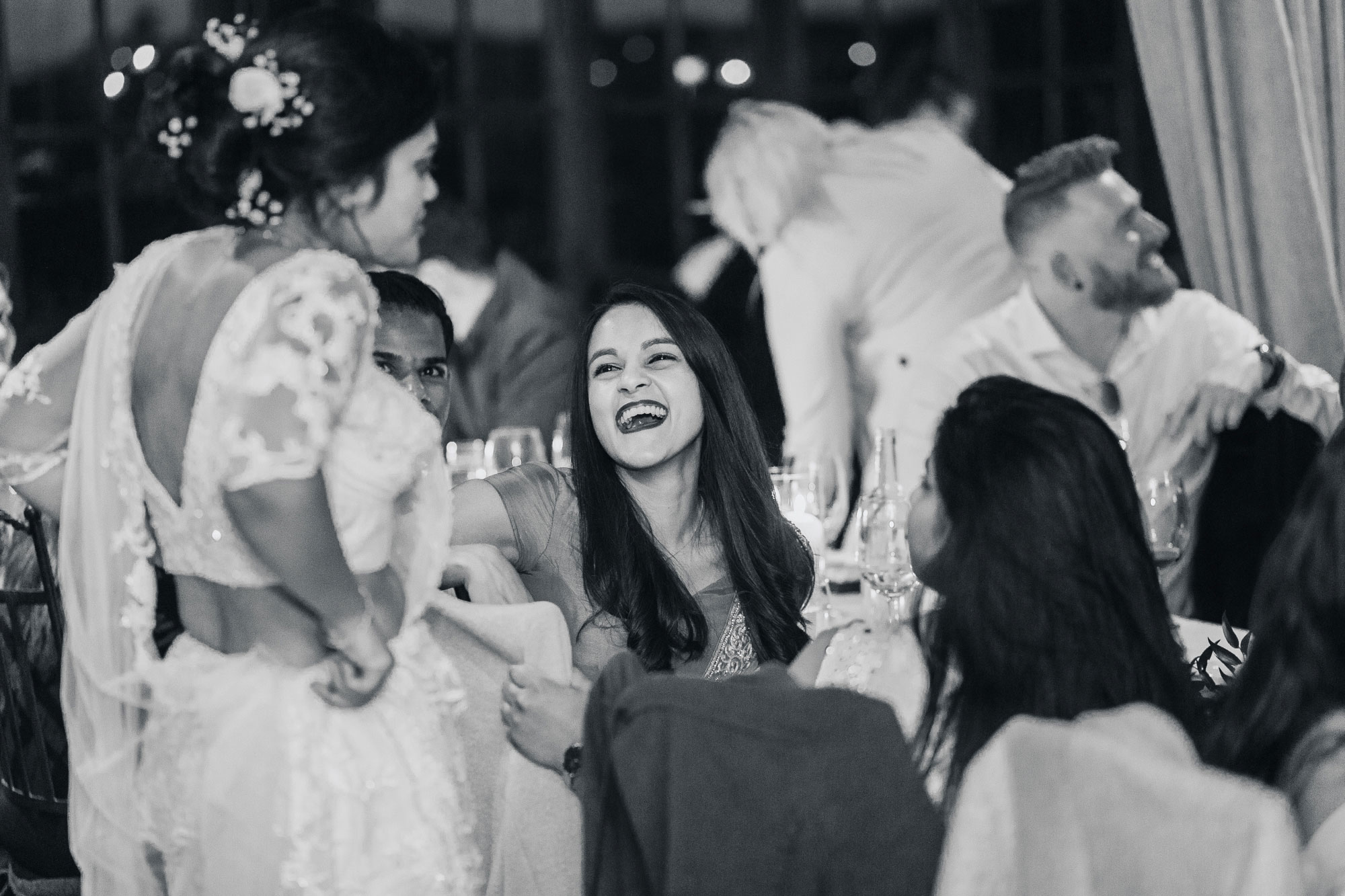 wedding guests laughing at reception