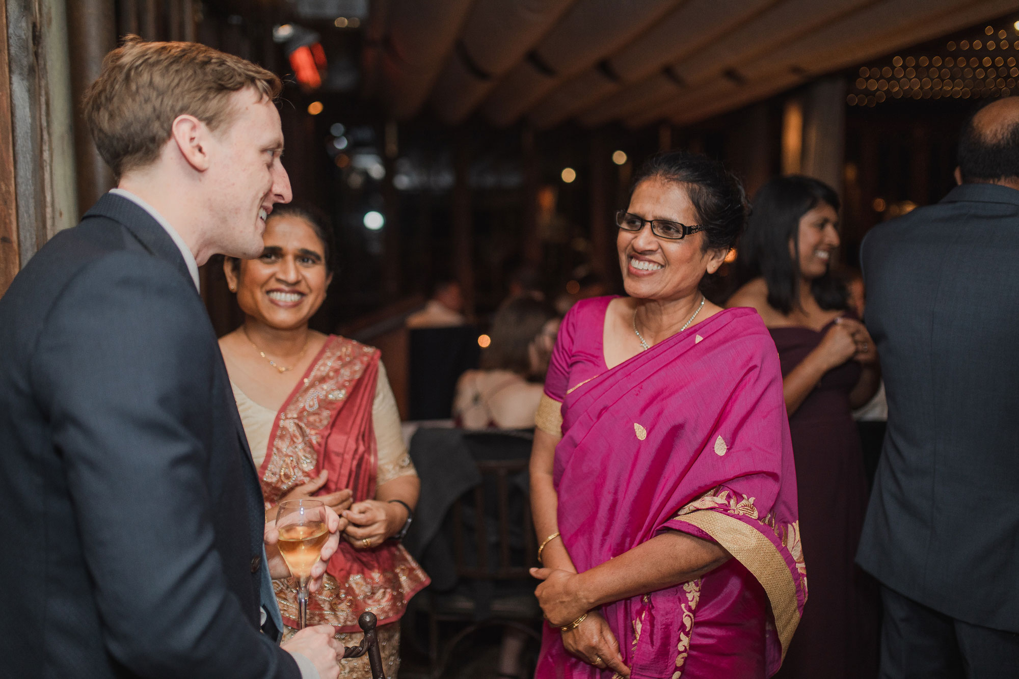 guests chatting with the groom