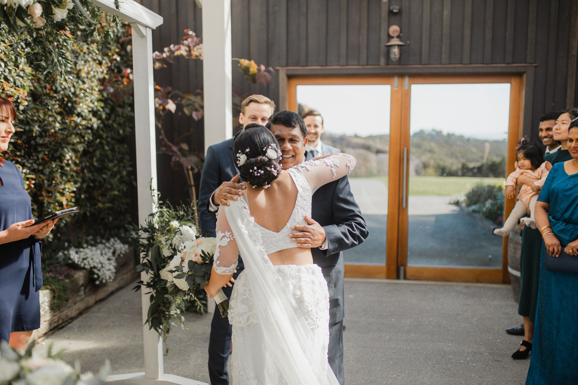 father of the bride hugging