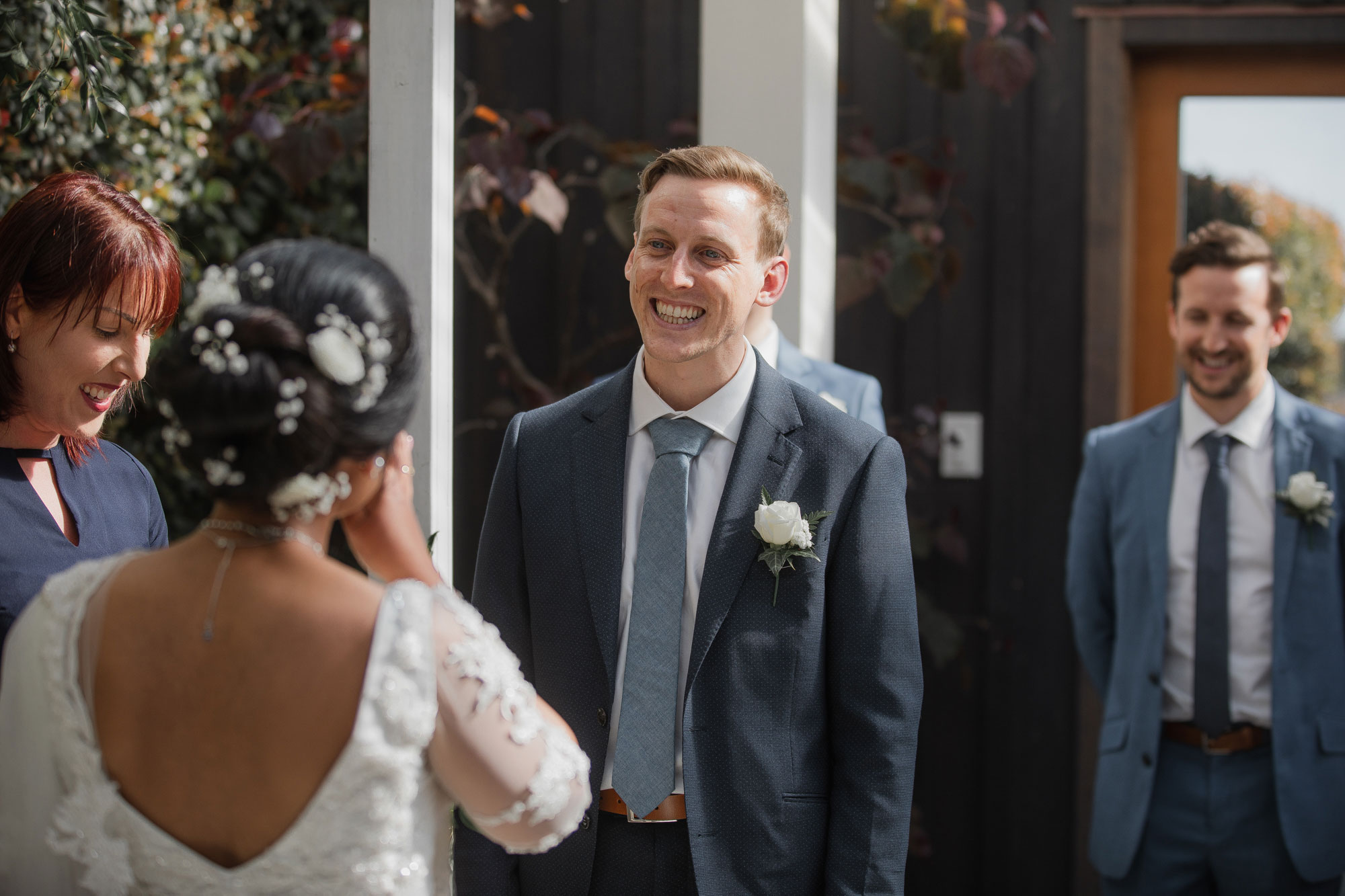 groom tearing up at the bride