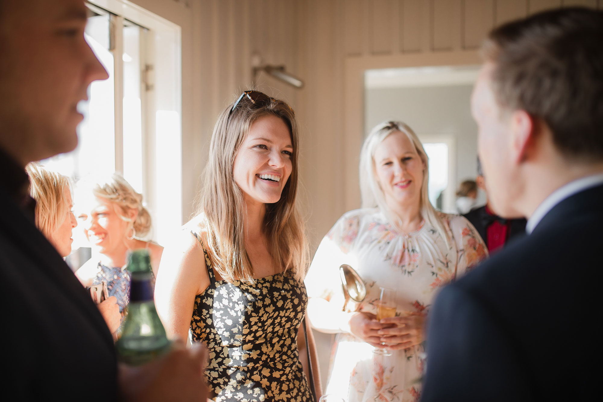 wedding guests talking to the groom