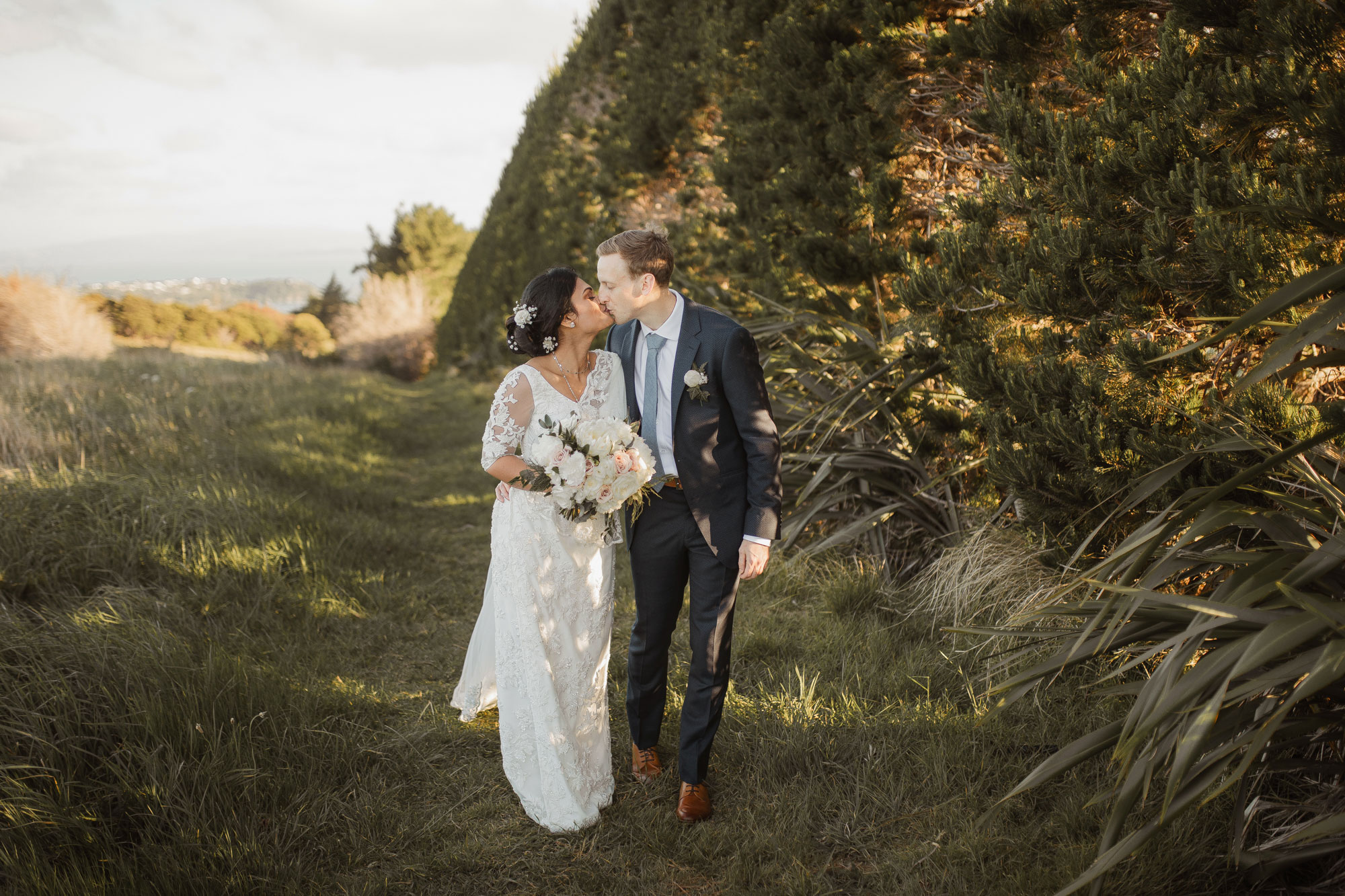 bride and groom kissing at mudbrick