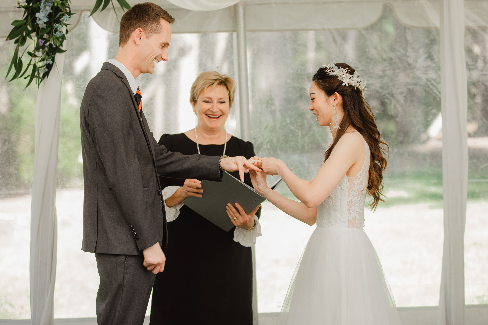 bride putting on wedding ring