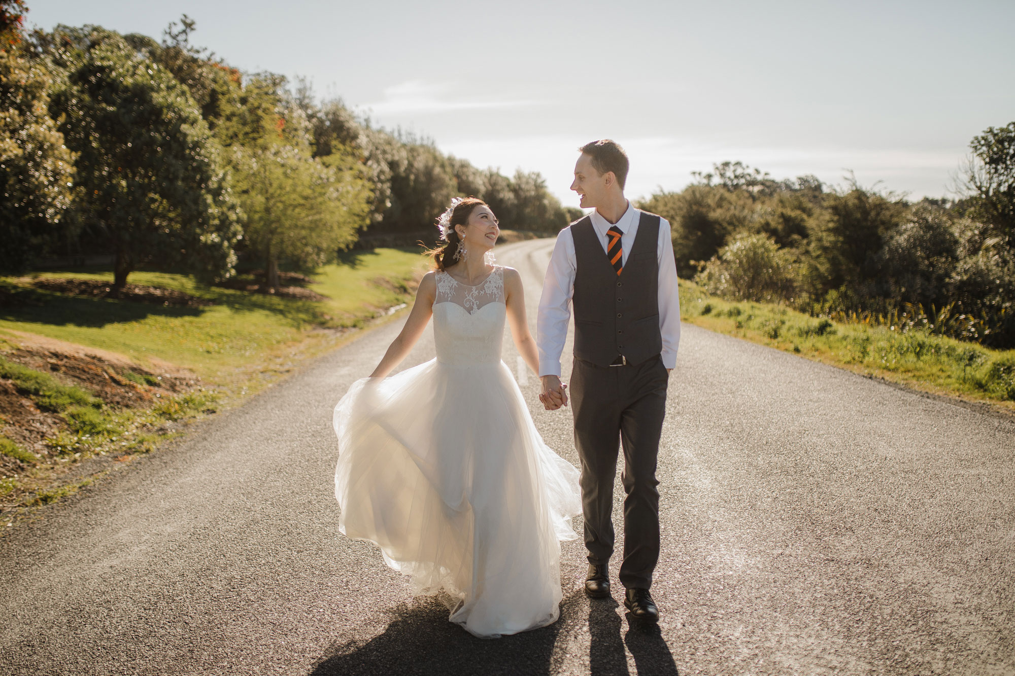 bride and groom open road