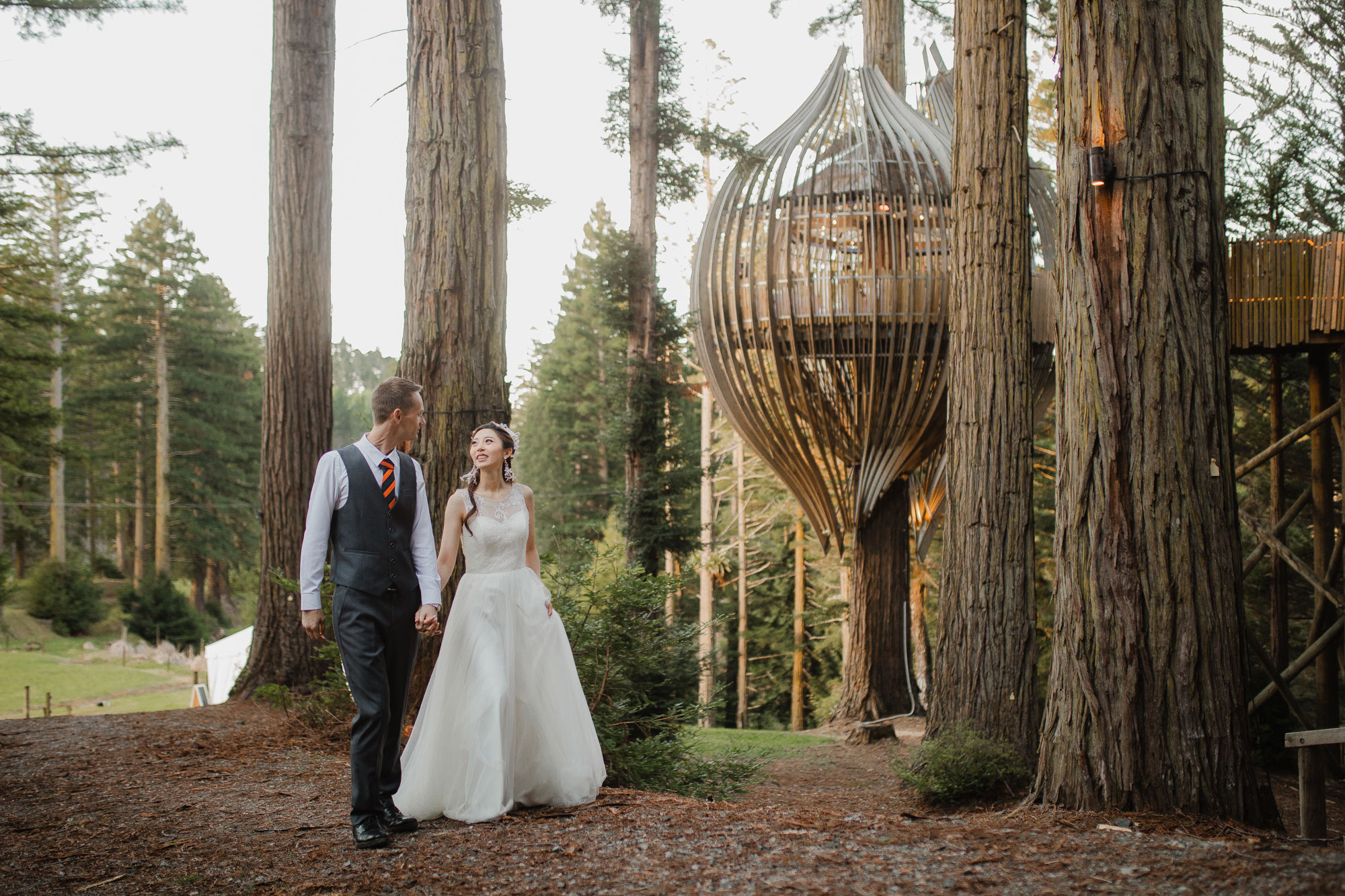 couple walking in redwoods treehouse