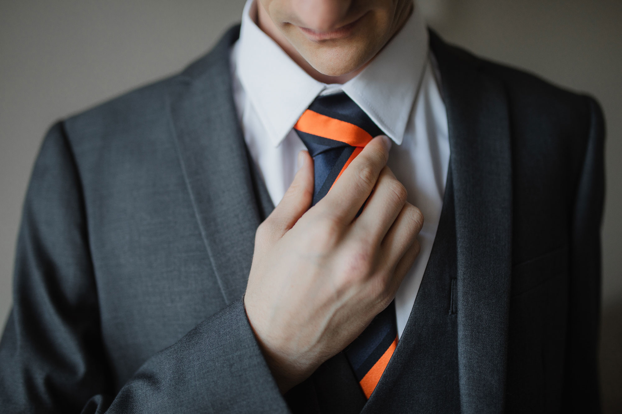 groom adjusting tie