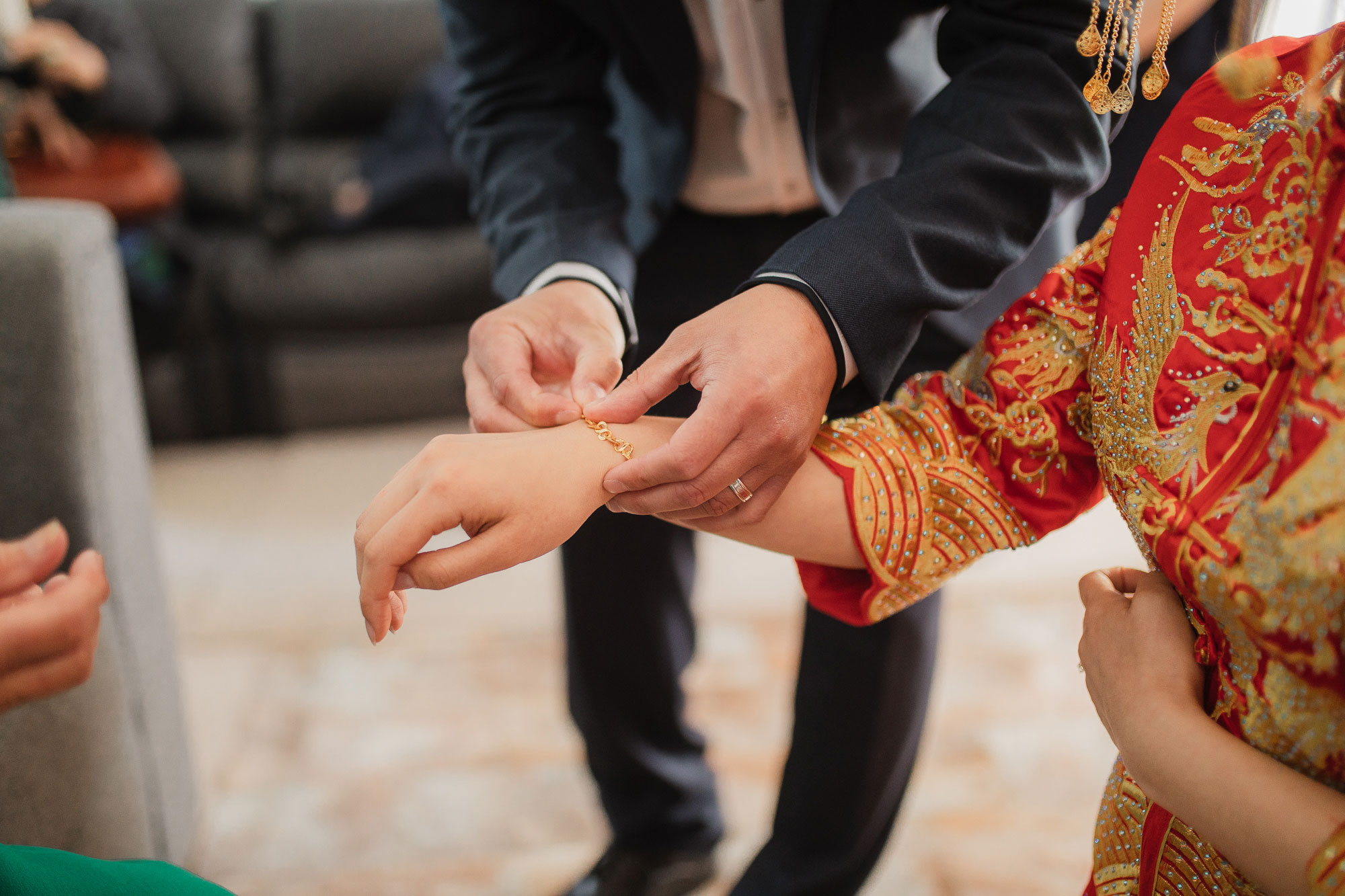 putting on jewelry for bride