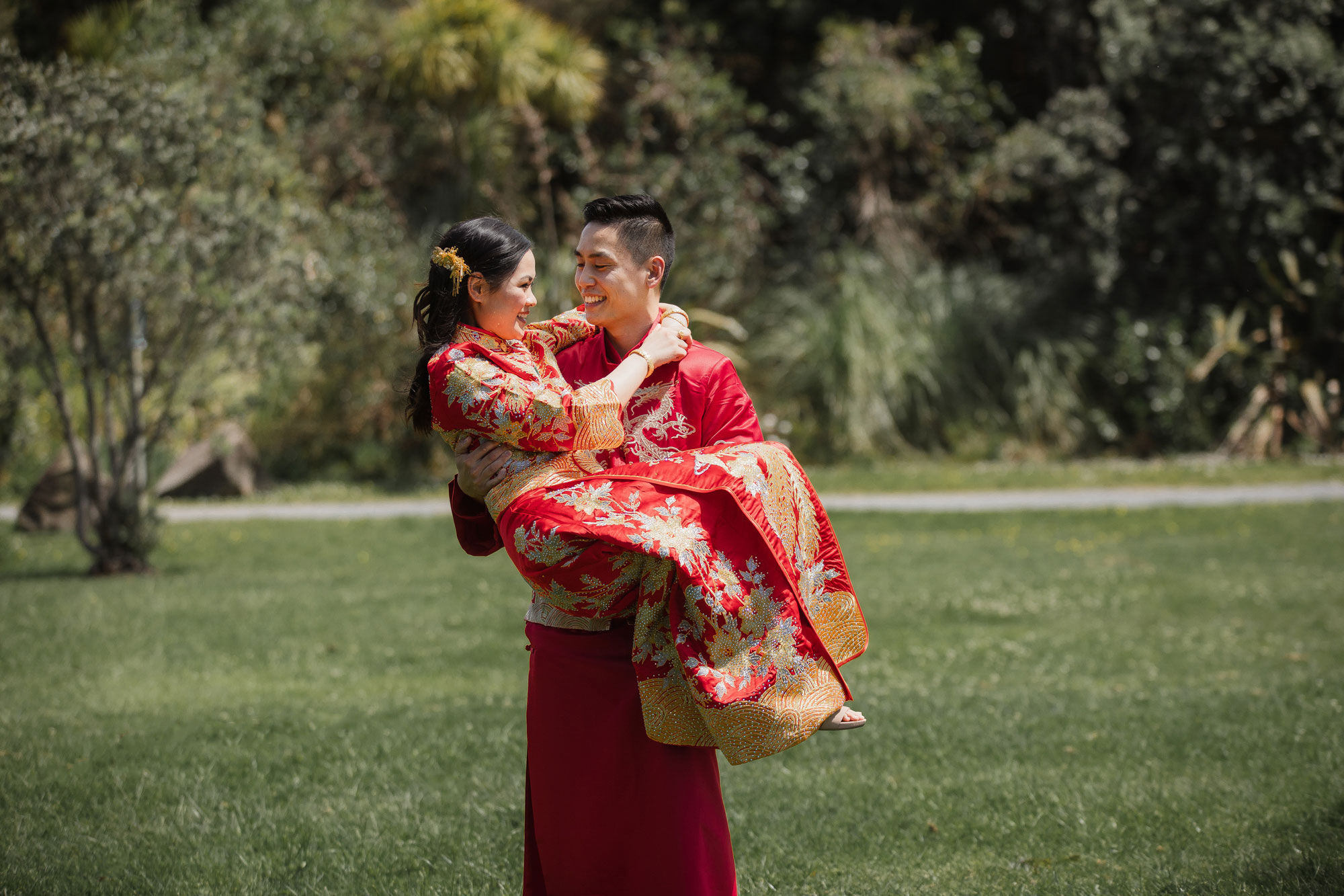 groom carrying bride