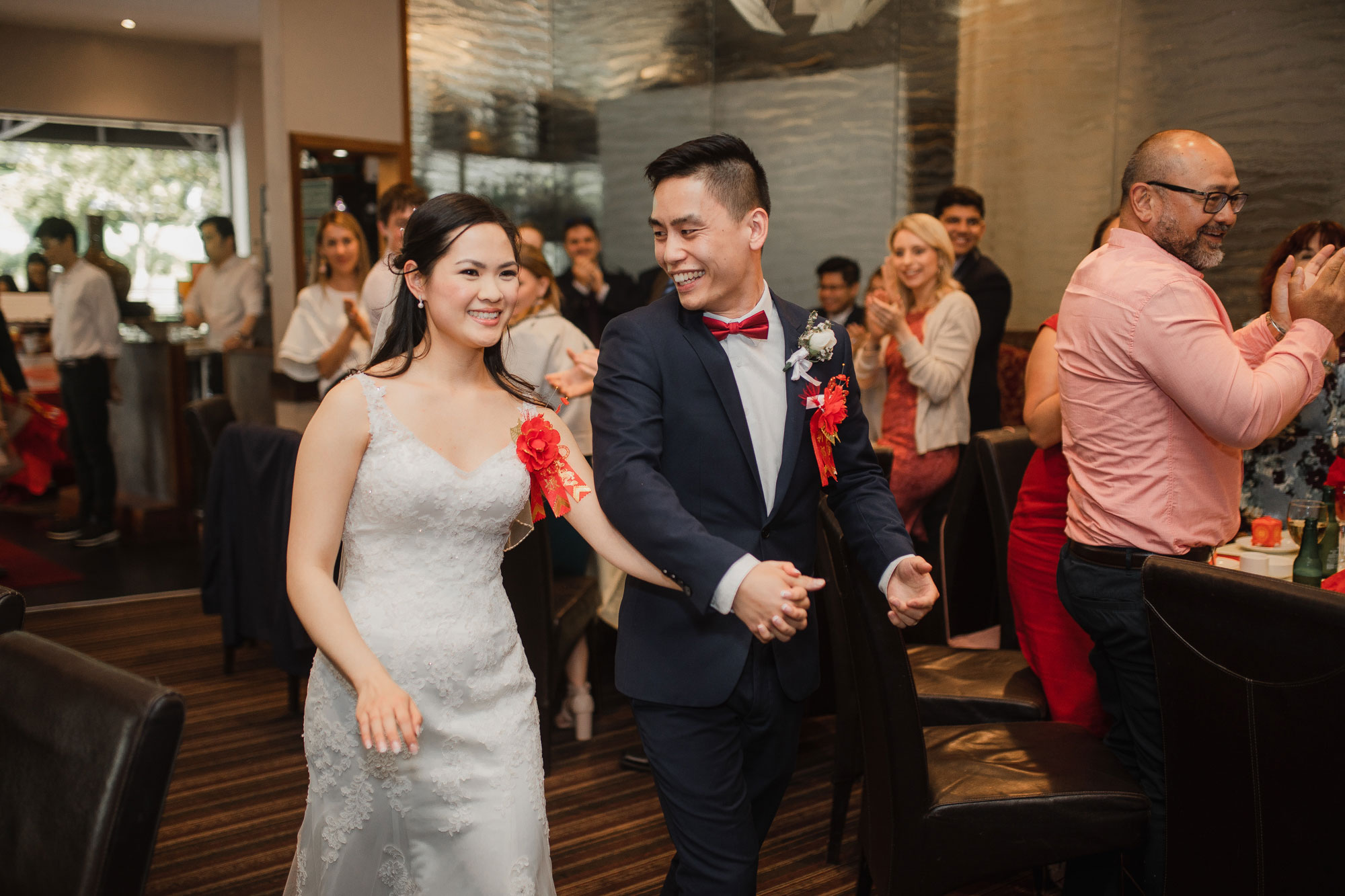 bride and groom arrive at auckland wedding reception