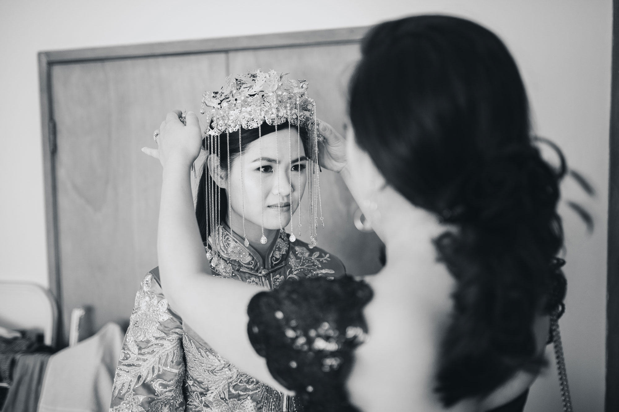 bride putting on head piece