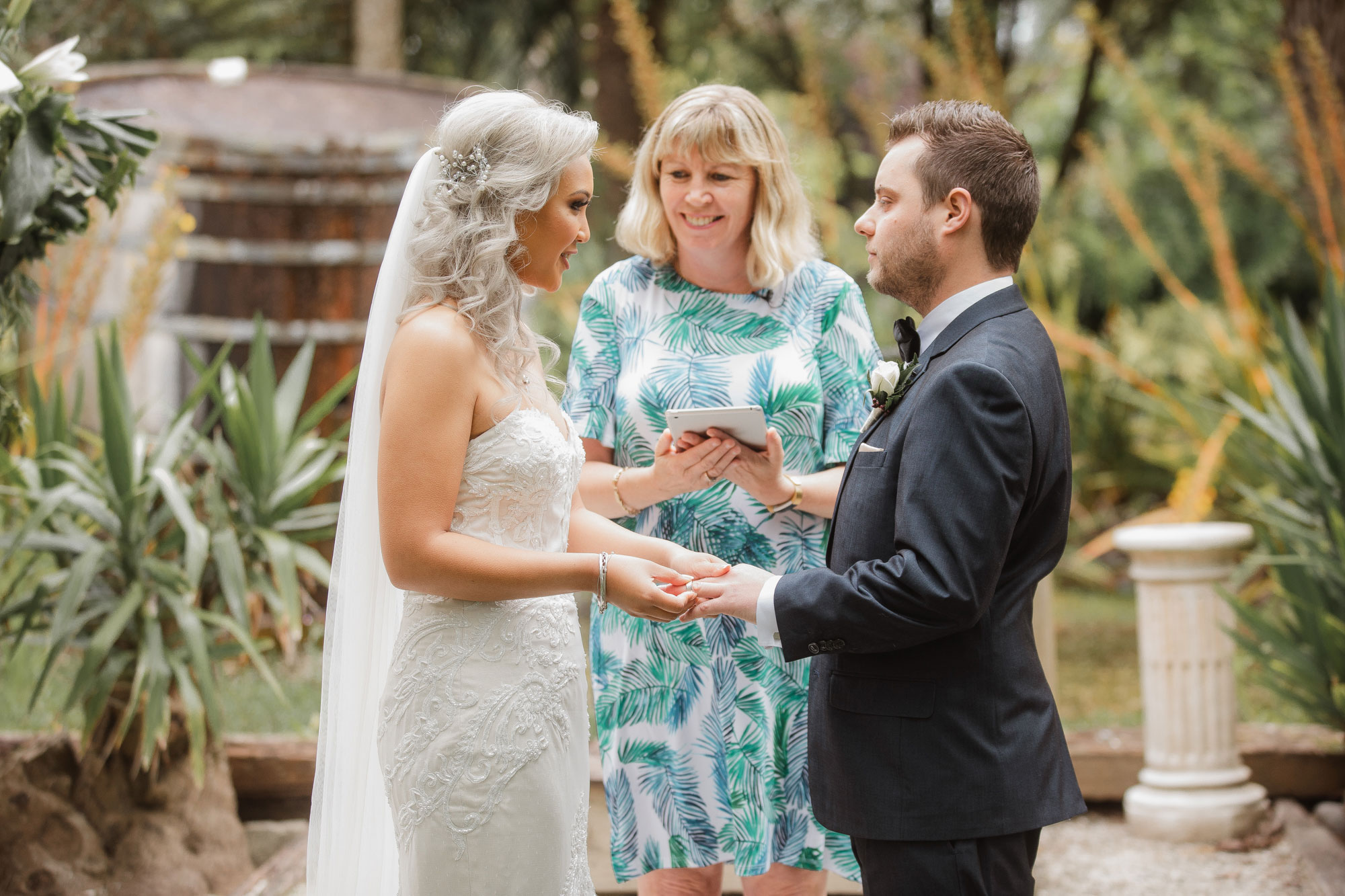 bride putting on wedding ring