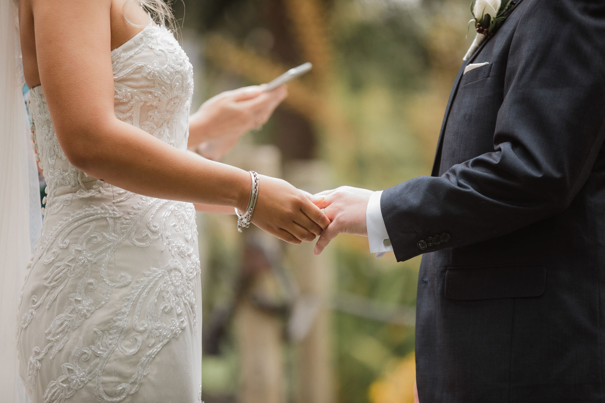 bride and groom holding hands at the wedding ceremony