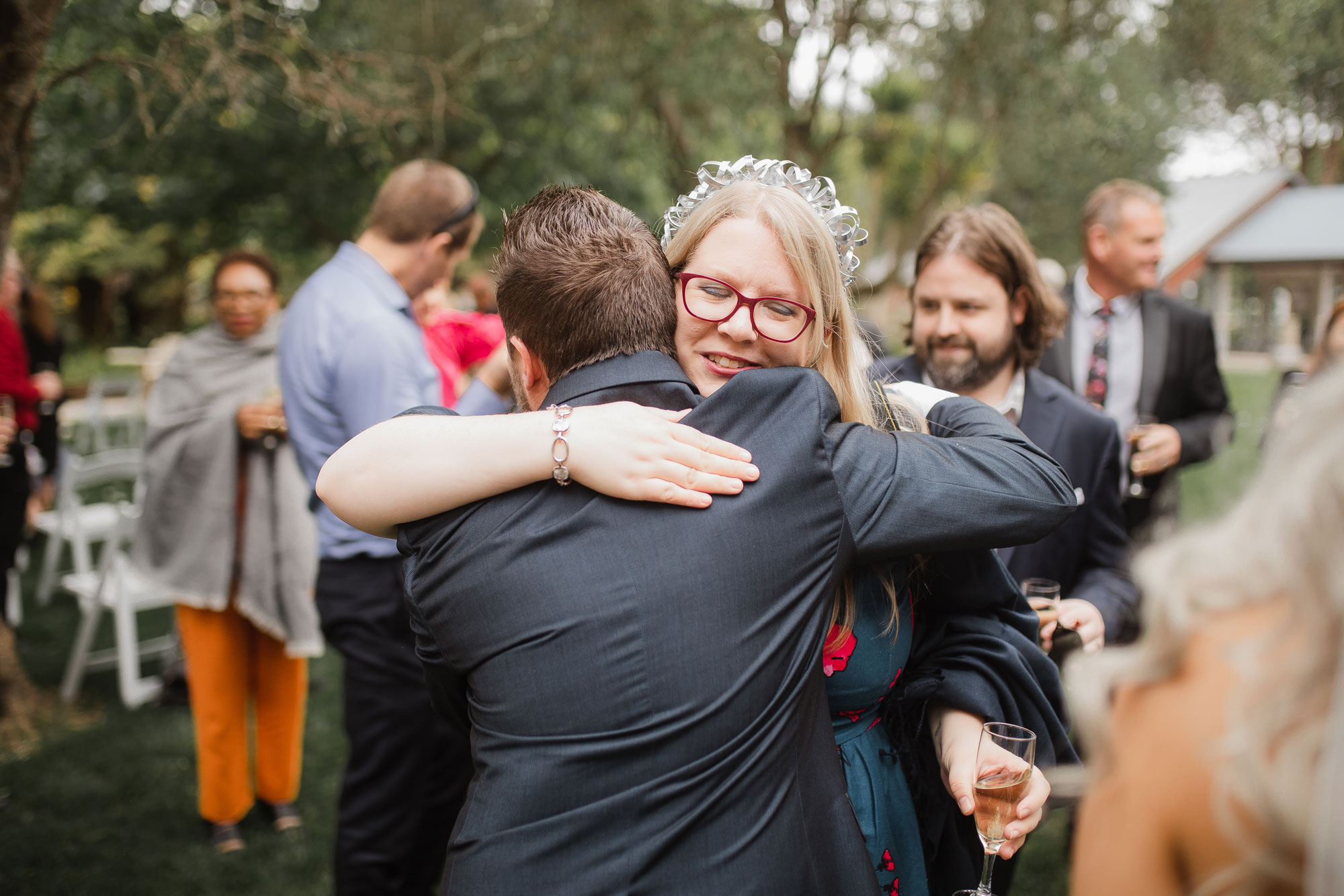 guests hugging the groom at wedding